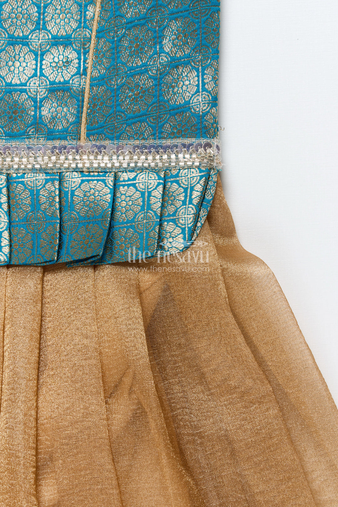 The Nesavu Pattu Pavadai Baby Girl Traditional Pattu Pavadai in Tissue Silk with Zari Finish Nesavu Nesavu baby girl golden tissue silk pattu pavadai with semi Banaras blouse for festive wear