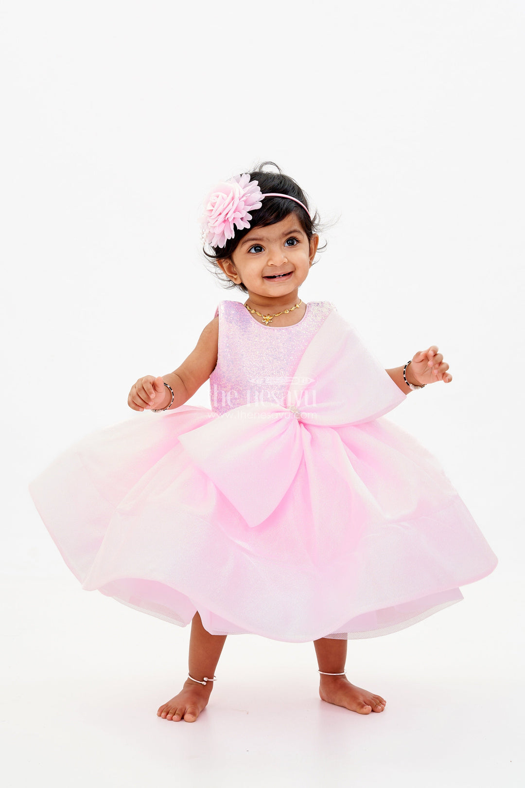 The Nesavu Baby Fancy Frock Baby Girls Fancy Frock in Pink Shimmer Fabric with Oversized Bow and Flared Silhouette Nesavu 16 (1Y) / Pink PF201B-16 Nesavu Baby Girls Fancy Frock Pink Shimmer Fabric Oversized Bow Flared Skirt