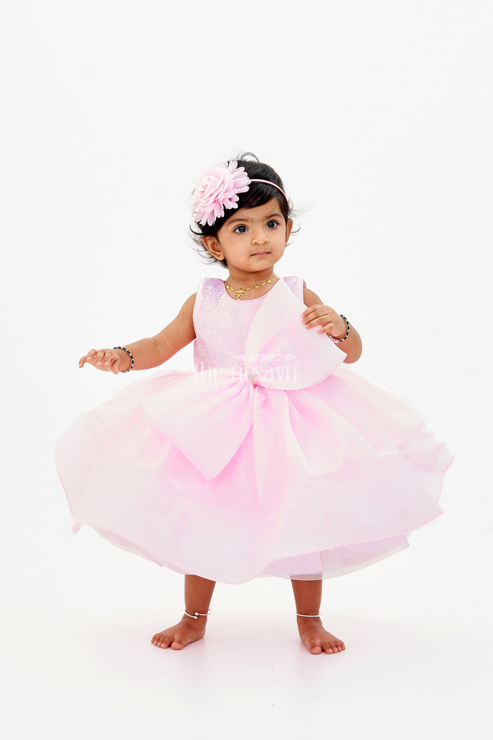 The Nesavu Baby Fancy Frock Baby Girls Fancy Frock in Pink Shimmer Fabric with Oversized Bow and Flared Silhouette Nesavu Nesavu Baby Girls Fancy Frock Pink Shimmer Fabric Oversized Bow Flared Skirt