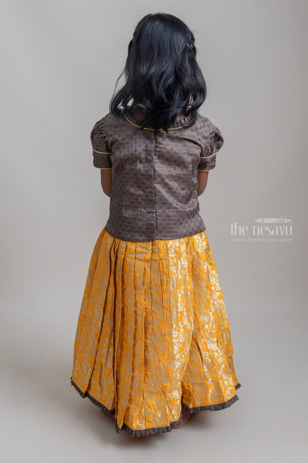 The Nesavu Pattu Pavadai Beautiful Traditional Brown Silk Blouse With Yellow Banarasi jacquard Pleated Designer Pattu Pavadai For Girls Nesavu Silk Pavada For Girls | Premium Silk Frock Onine | The Nesavu
