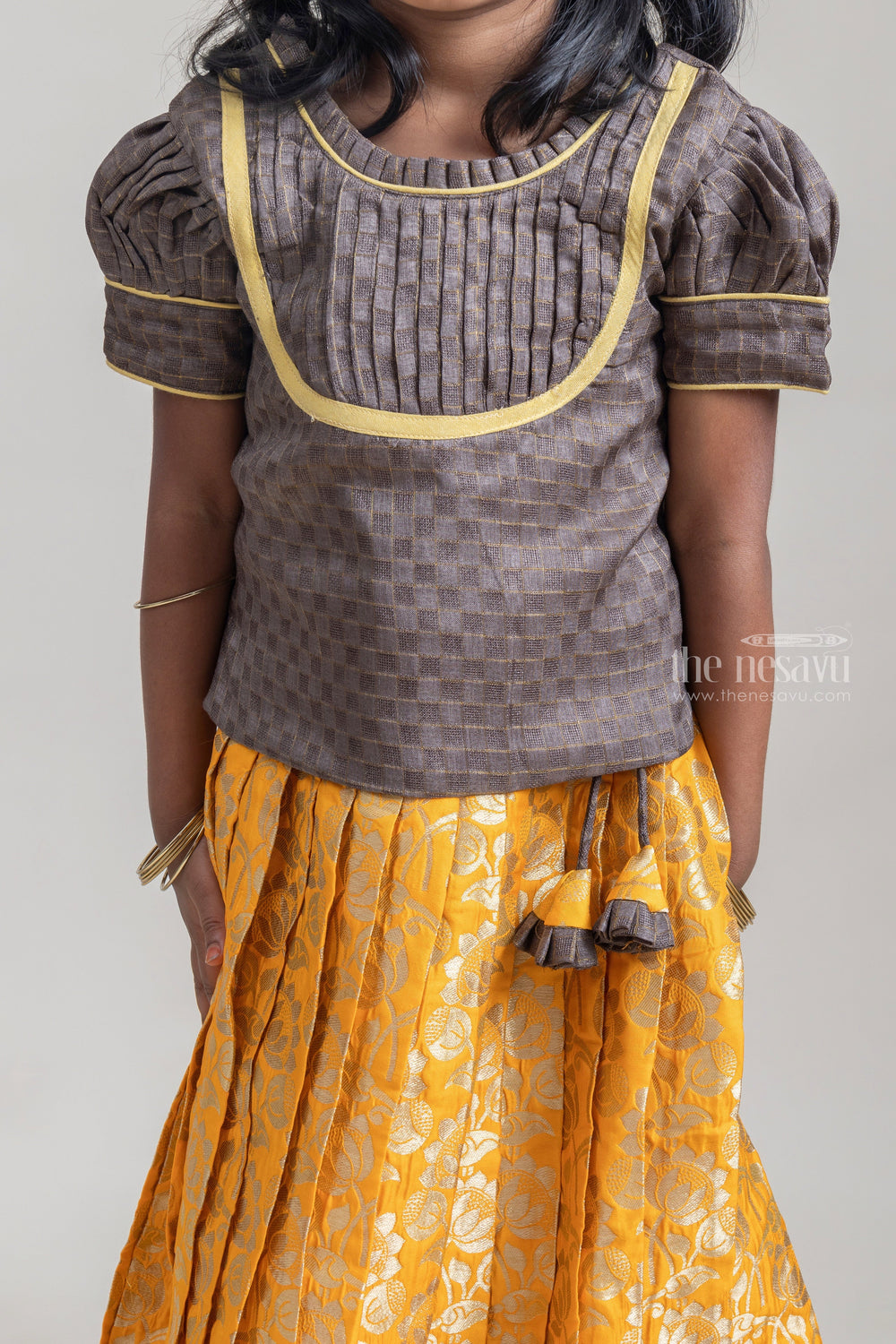 The Nesavu Pattu Pavadai Beautiful Traditional Brown Silk Blouse With Yellow Banarasi jacquard Pleated Designer Pattu Pavadai For Girls Nesavu Silk Pavada For Girls | Premium Silk Frock Onine | The Nesavu