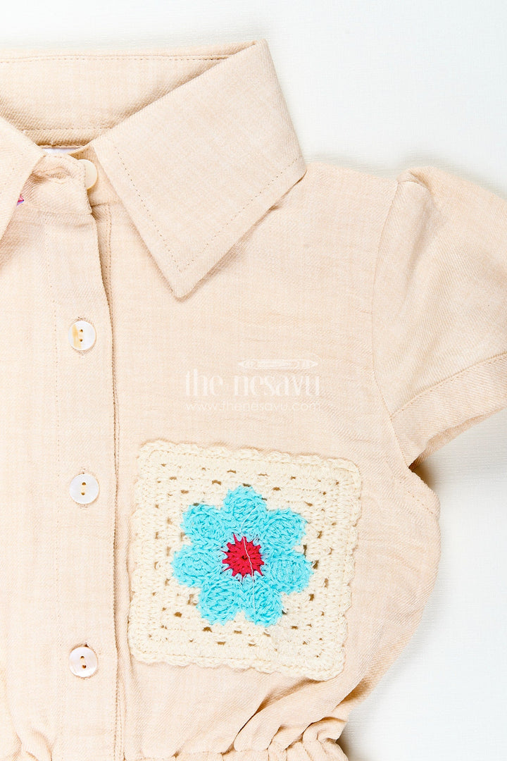 The Nesavu Girls Cotton Frock Beige girls cotton frock with collar and crochet flower patch Nesavu Nesavu beige girls cotton frock with collar and hand-crochet flower patch