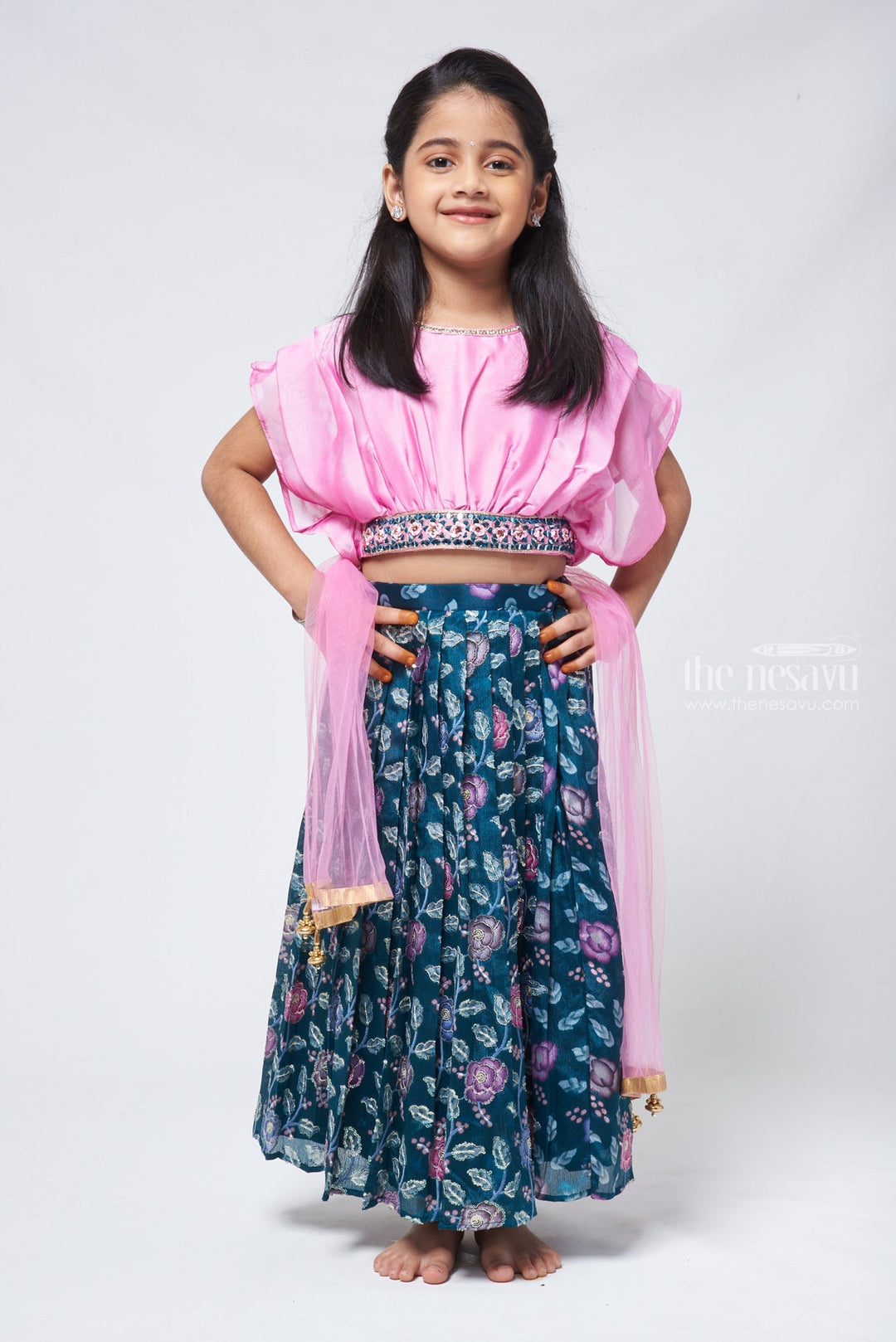 The Nesavu Lehenga & Ghagra Blossom Green: Girls Floral Lehanga Choli with Pleated Pink Blouse Nesavu 16 (1Y) / Green GL351A-16 Enhance your little girls charm with this captivating Floral Printed Knife Pleated Designer Green Lehenga Choli set. The green lehenga showcases a stunning floral print and knife pleats, exuding sophistication and beauty in her outfit.