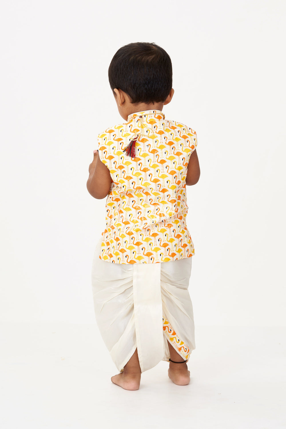 The Nesavu Boys Dothi Set Boys Cotton Dhoti Pant Set with Yellow and Orange Flamingo Print Jacket in Cotton Blend Nesavu Nesavu Boys Cotton Dhoti Pant Set Flamingo Printed Sleeveless Jacket Cream Bottom