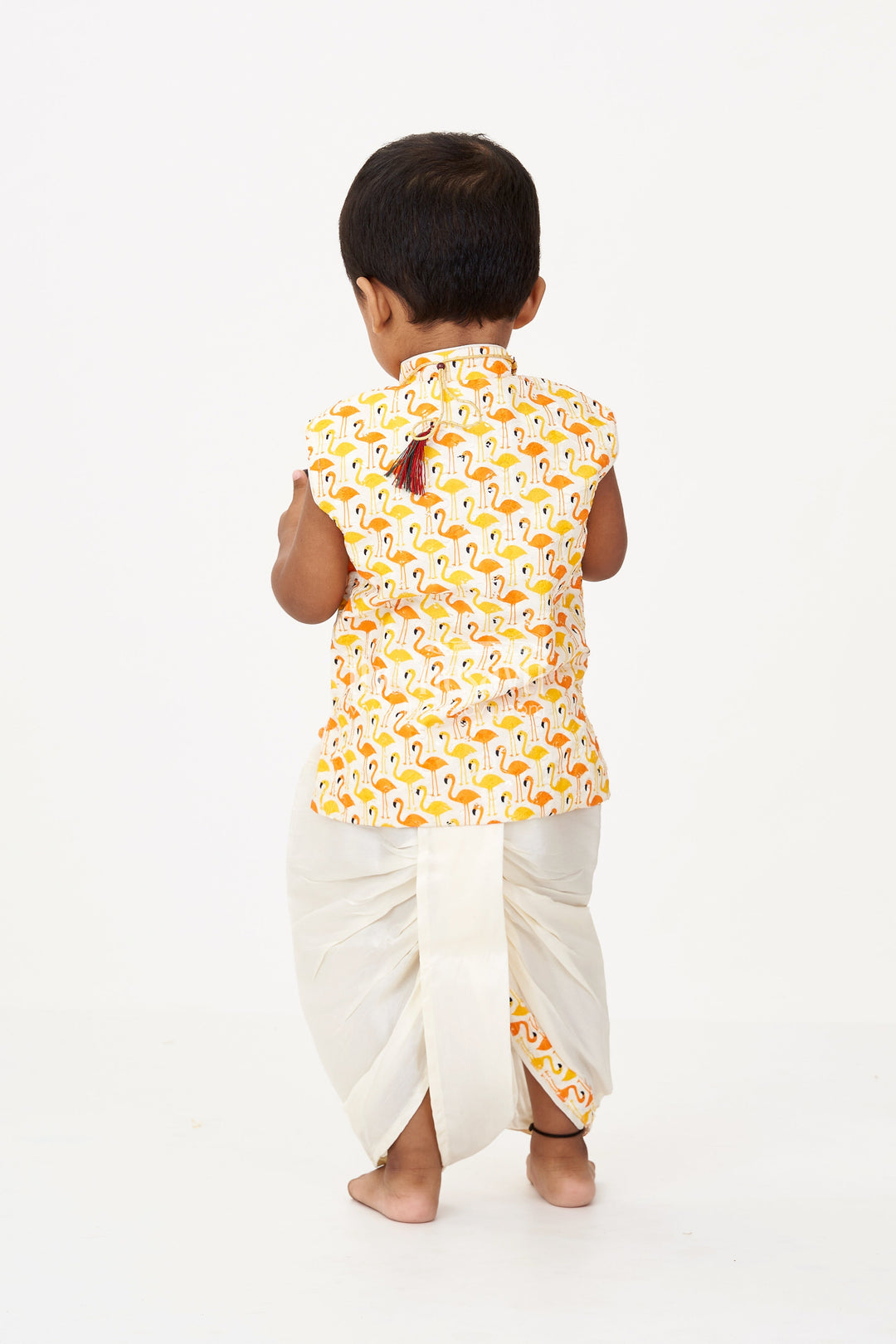 The Nesavu Boys Dothi Set Boys Cotton Dhoti Pant Set with Yellow and Orange Flamingo Print Jacket in Cotton Blend Nesavu Nesavu Boys Cotton Dhoti Pant Set Flamingo Printed Sleeveless Jacket Cream Bottom