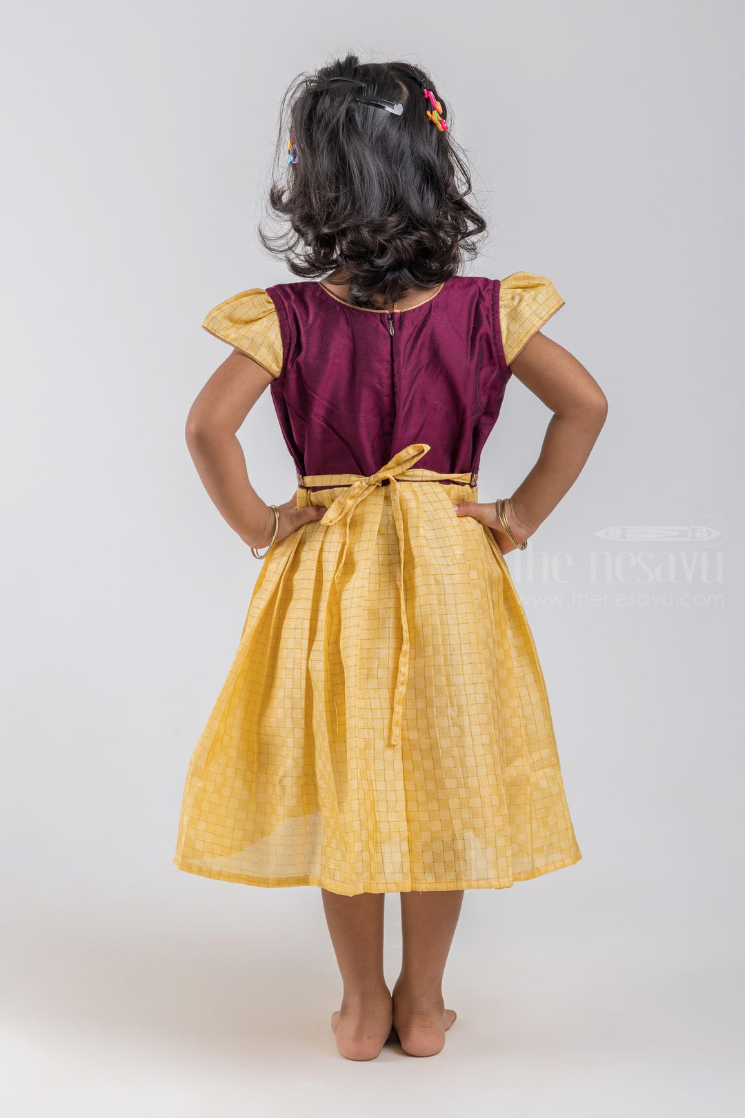 The Nesavu Silk Embroidered Frock Checkered Pattern Yellow Semi Silk Frock with Purple Yoke for Girls psr silks Nesavu