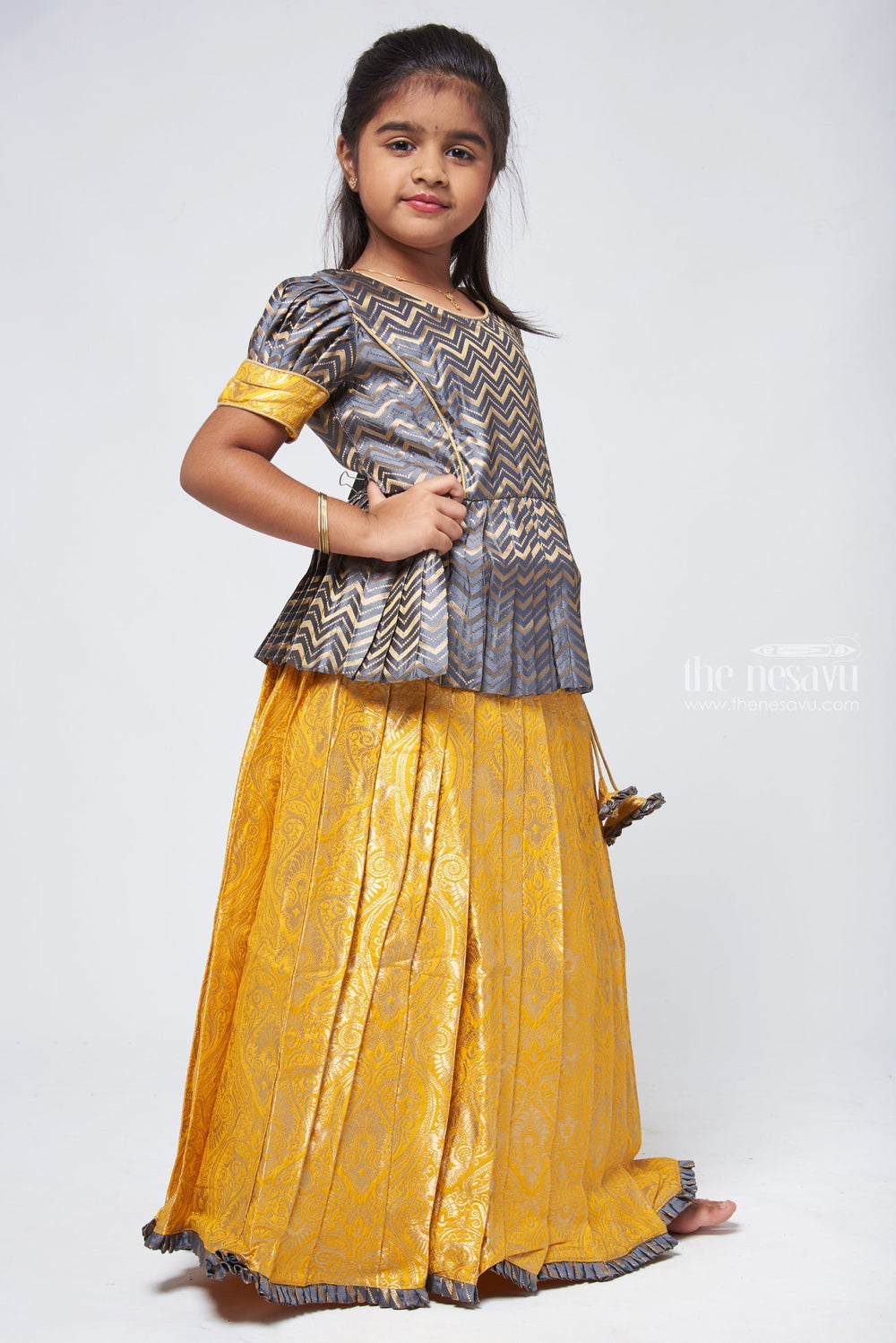 The Nesavu Pattu Pavadai Chic Zig Zag Gray Peplum Top with Banarasi Designer Pattu Pavadai: Festive Delight for Girls Nesavu Banarasi Designer Yellow Pattu Pavadai | Pattu Pavadai New Model | The Nesavu