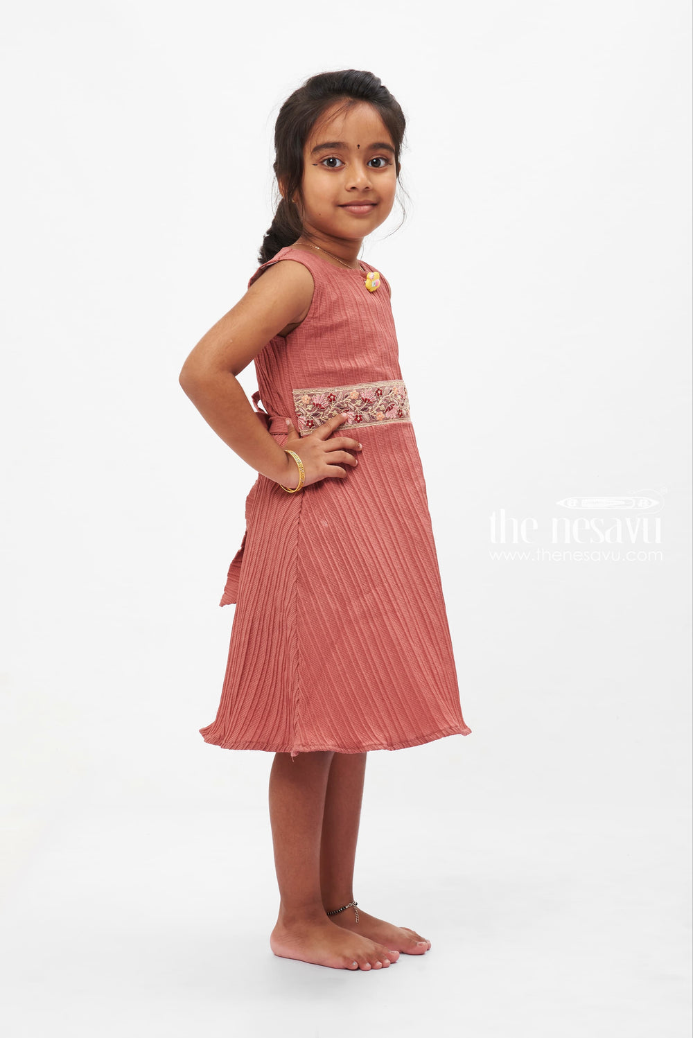 The Nesavu Girls Fancy Frock Coral Charm Pleated Dress: Sleeveless Delight with Floral Brooch for Girls Nesavu Girls' Coral Pleated Dress with Floral Brooch | Vibrant Party Wear | The Nesavu