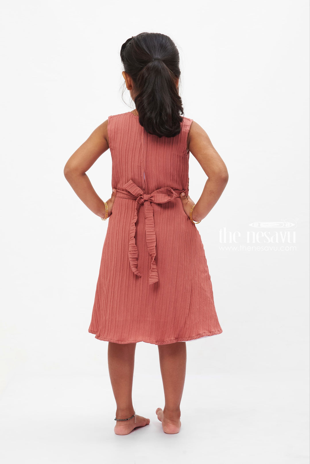 The Nesavu Girls Fancy Frock Coral Charm Pleated Dress: Sleeveless Delight with Floral Brooch for Girls Nesavu Girls' Coral Pleated Dress with Floral Brooch | Vibrant Party Wear | The Nesavu