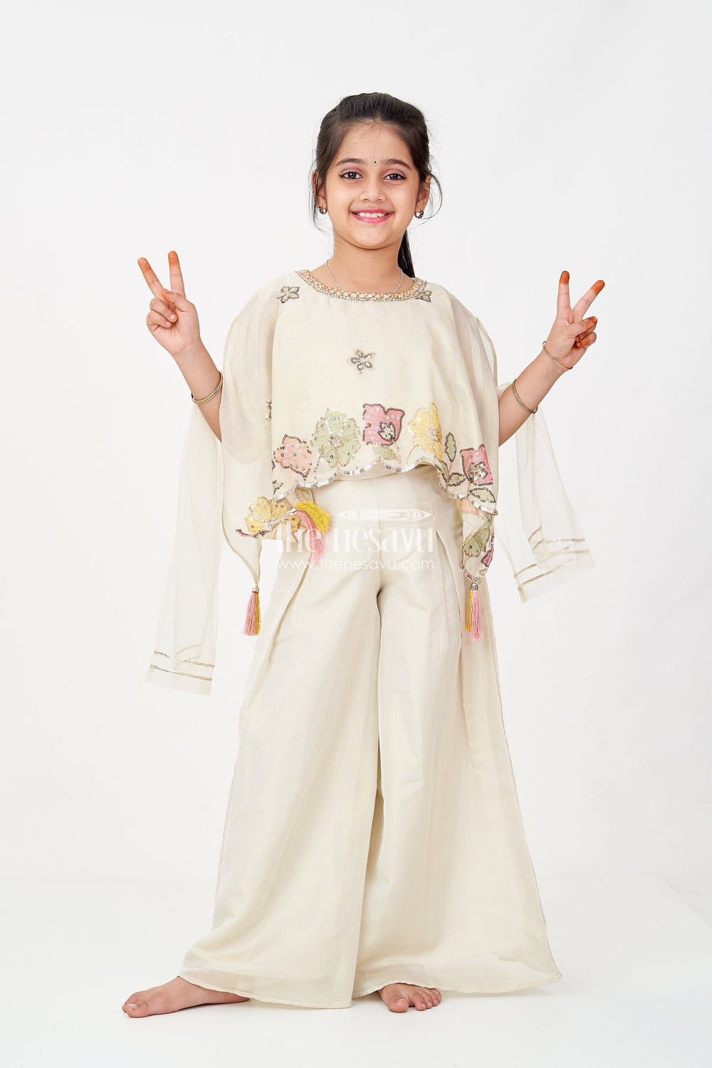 The Nesavu Girls Sharara / Plazo Set Cream Color Sharara Set for Girls in Shimmer Viscose Silk with Designer Embroidered Cape and Tassels Nesavu 16 (1Y) / Cream GPS599A-16 Nesavu Girls Cream Color Sharara Set Embroidered Shimmer Cape Top Flared Silk Pants