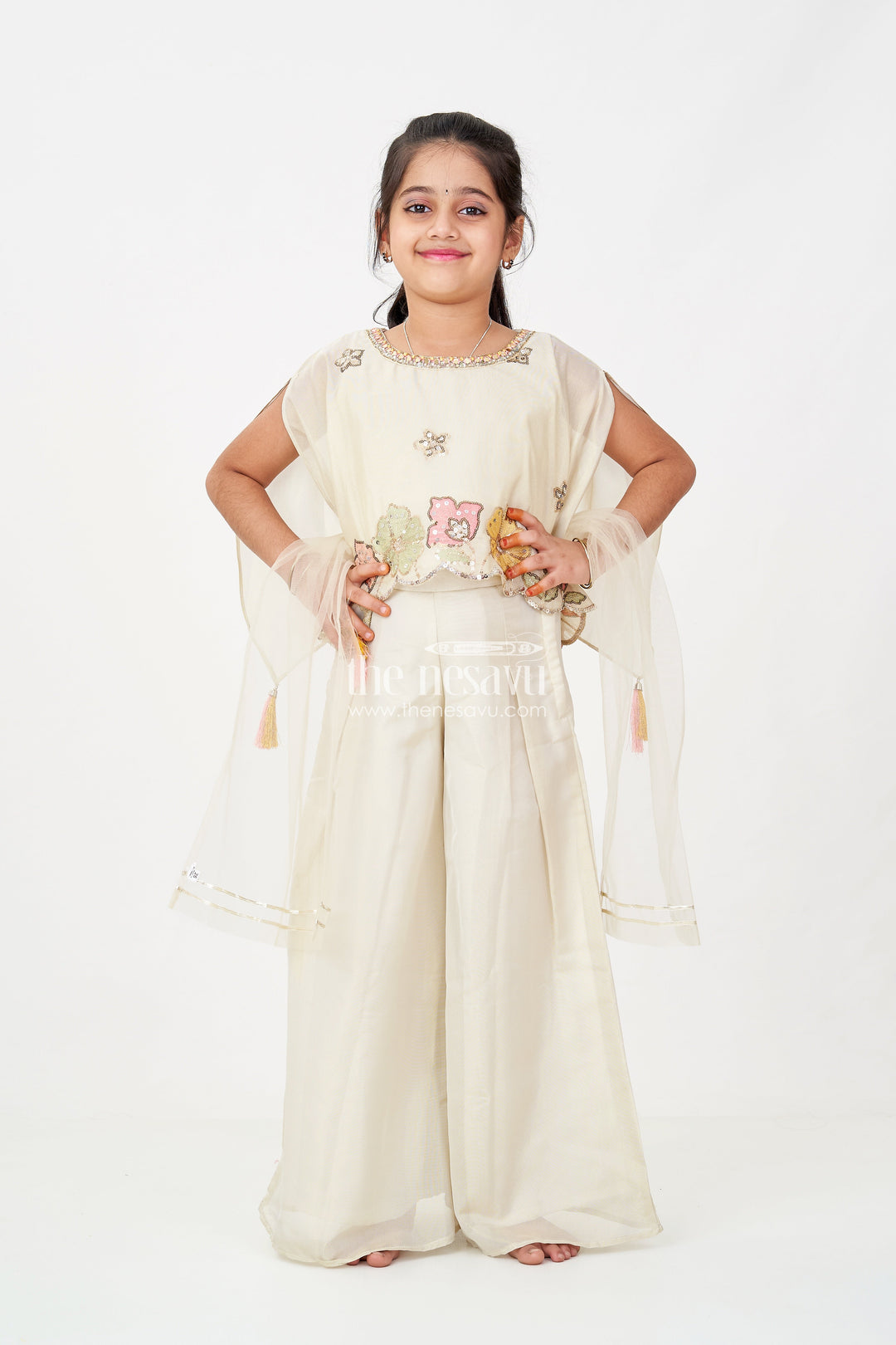 The Nesavu Girls Sharara / Plazo Set Cream Color Sharara Set for Girls in Shimmer Viscose Silk with Designer Embroidered Cape and Tassels Nesavu Nesavu Girls Cream Color Sharara Set Embroidered Shimmer Cape Top Flared Silk Pants