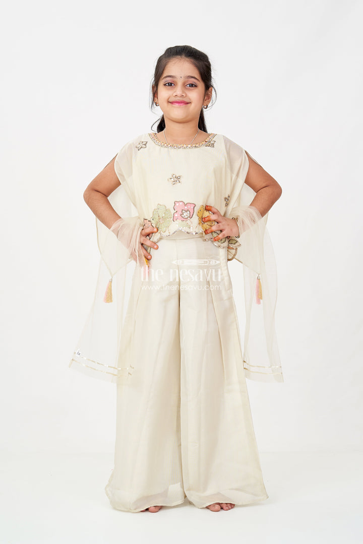 The Nesavu Girls Sharara / Plazo Set Cream Color Sharara Set for Girls in Shimmer Viscose Silk with Designer Embroidered Cape and Tassels Nesavu Nesavu Girls Cream Color Sharara Set Embroidered Shimmer Cape Top Flared Silk Pants