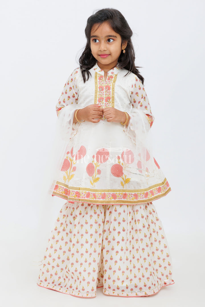 The Nesavu Girls Sharara / Plazo Set Cream Cotton ALine Top with Floral Ghagra Set for Girls with Mirror Work Embellishments Nesavu Cream and Peach Cotton A-Line Top and Floral Ghagra Set for Girls with Mirror Work Nesavu