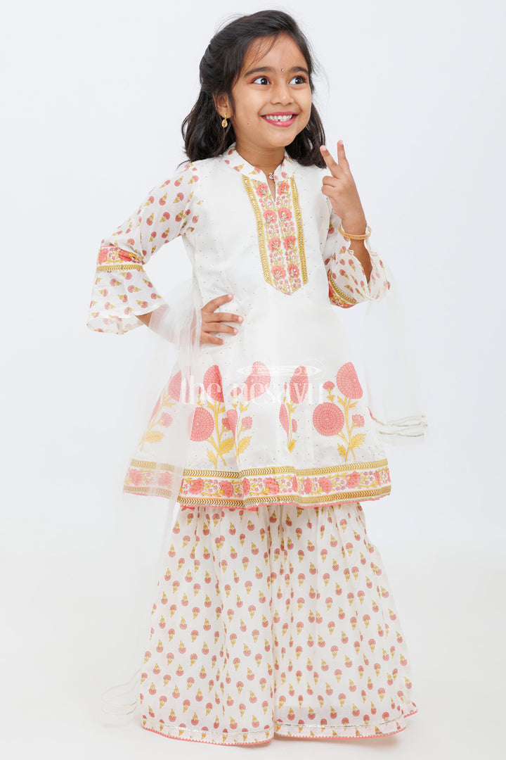 The Nesavu Girls Sharara / Plazo Set Cream Cotton ALine Top with Floral Ghagra Set for Girls with Mirror Work Embellishments Nesavu Cream and Peach Cotton A-Line Top and Floral Ghagra Set for Girls with Mirror Work Nesavu