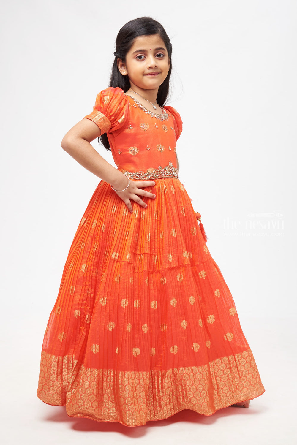 The Nesavu Girls Silk Gown Crimson Elegance: Orange Anarkali with Gilded Accents and Tassel Detailing Nesavu Royal Affair: Anarkali Gowns for Timeless Grace | The Nesavu