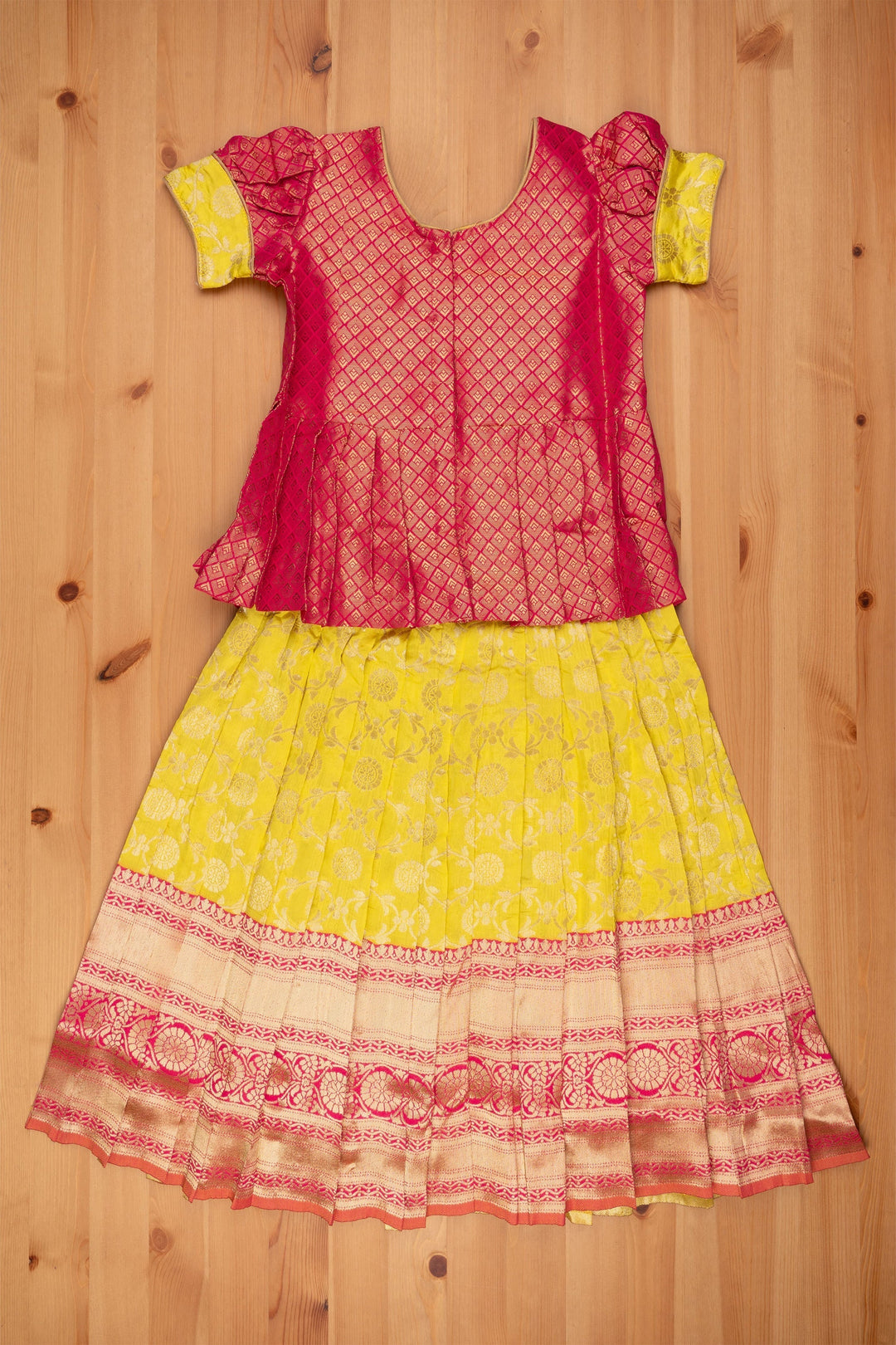 The Nesavu Pattu Pavadai Dazzling Brocade Pink Peplum Top with Banarasi Yellow Pattu Langa: Classic Silk Beauty Nesavu Banaras Silk Pattu Pavadai | Pattu Pavadai Sattai Designs | The Nesavu