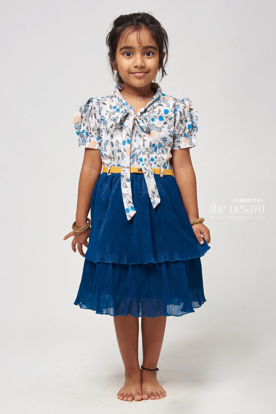 The Nesavu Frocks & Dresses Double Layer Flared Blue Frock - Floral Tie Neck Design Nesavu 20 (3Y) / Blue GFC1104A-20 Floral Printed Fancy Frock | Latest Frocks for Girls | The Nesavu Elevate your childs wardrobe with our Floral Printed Tie Neck with Double Layer Flared Blue Frock. The floral print adds elegance, while the sleeveless design ensures comfort. The tie neck detail adds a stylish touch, and the double layer flared skirt creates a graceful look.