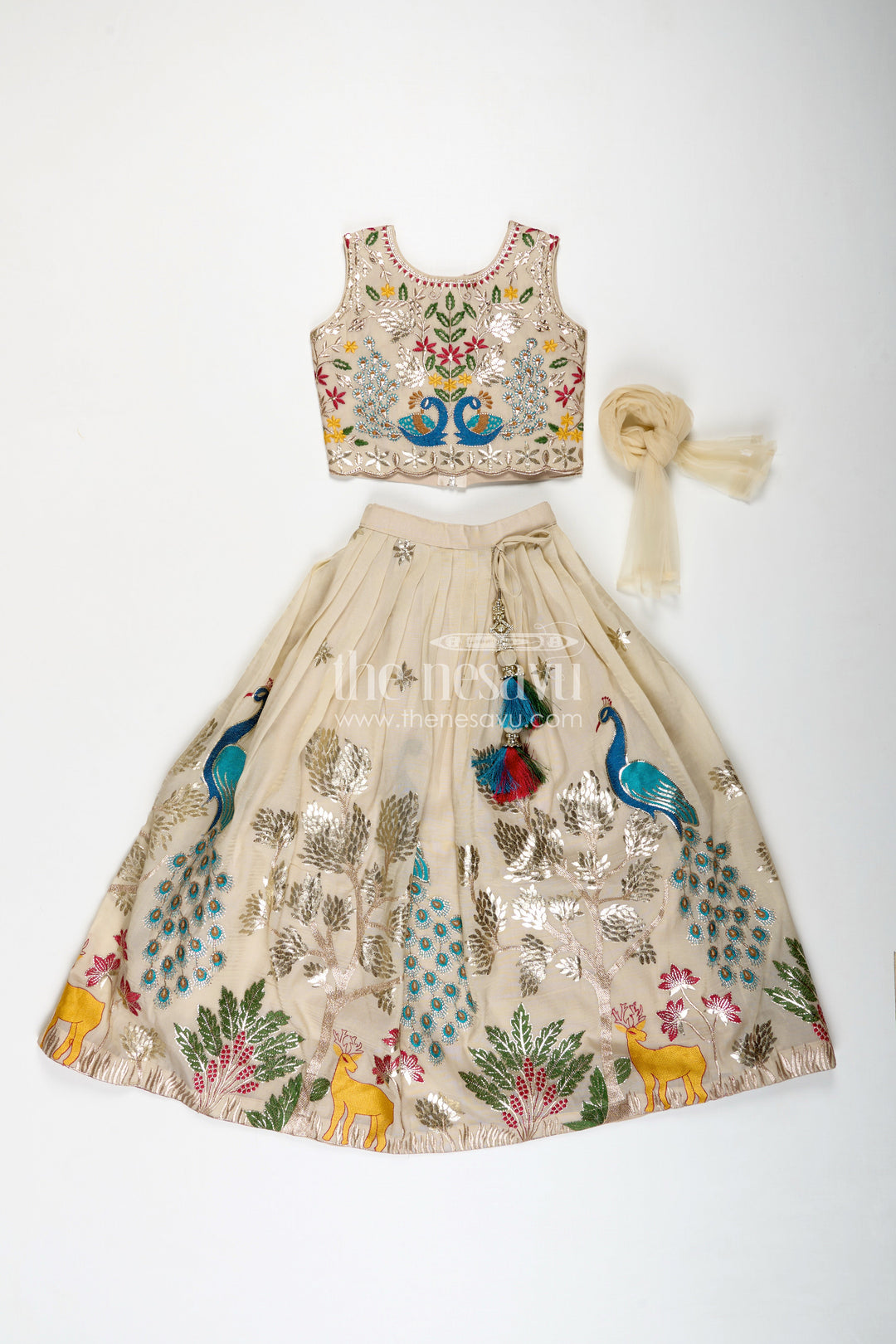 The Nesavu Girls Lehenga Choli Dress Lacha Beige Kora Silk Cotton Girls Lehenga Choli with Peacock and Deer Thread Embroidery Nesavu Nesavu Dress Lacha Girls Beige Kora Silk Cotton Lehenga Choli Peacock Embroidery Dupatta