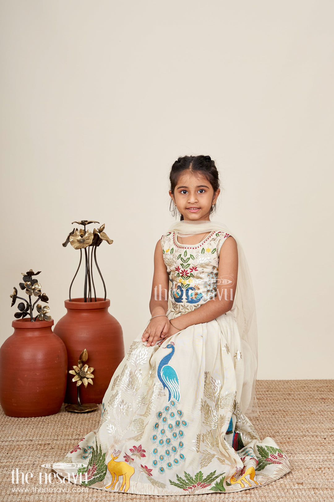 The Nesavu Girls Lehenga Choli Dress Lacha Beige Kora Silk Cotton Girls Lehenga Choli with Peacock and Deer Thread Embroidery Nesavu Nesavu Dress Lacha Girls Beige Kora Silk Cotton Lehenga Choli Peacock Embroidery Dupatta