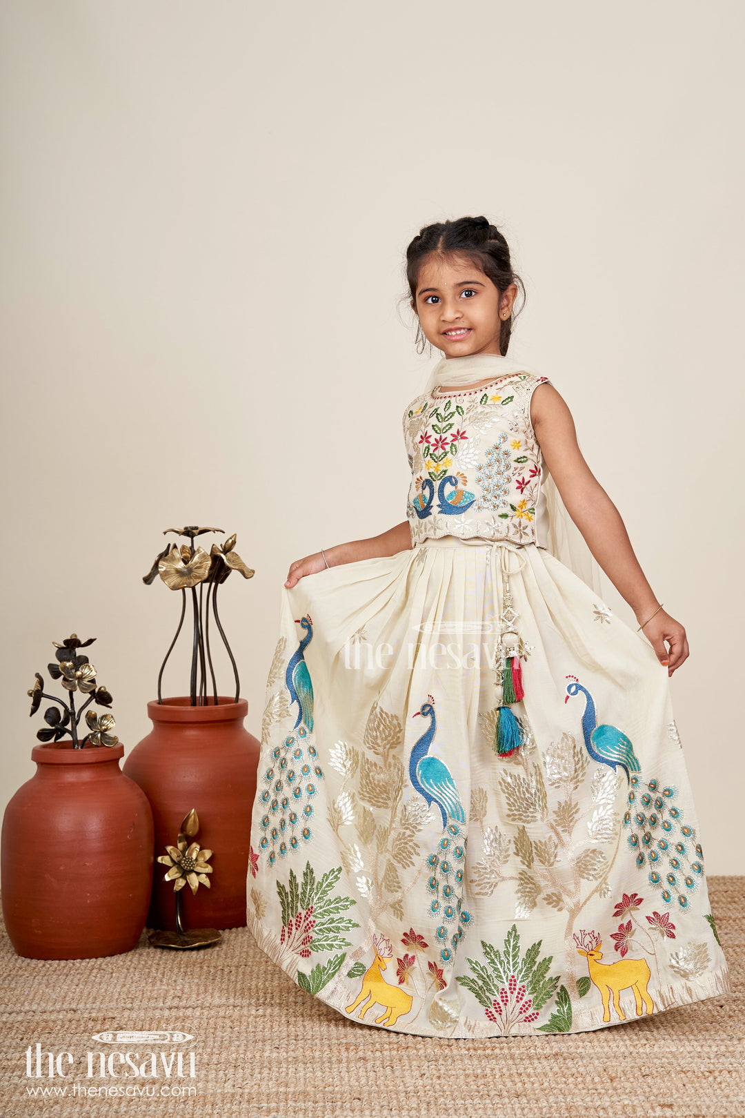 The Nesavu Girls Lehenga Choli Dress Lacha Beige Kora Silk Cotton Girls Lehenga Choli with Peacock and Deer Thread Embroidery Nesavu Nesavu Dress Lacha Girls Beige Kora Silk Cotton Lehenga Choli Peacock Embroidery Dupatta