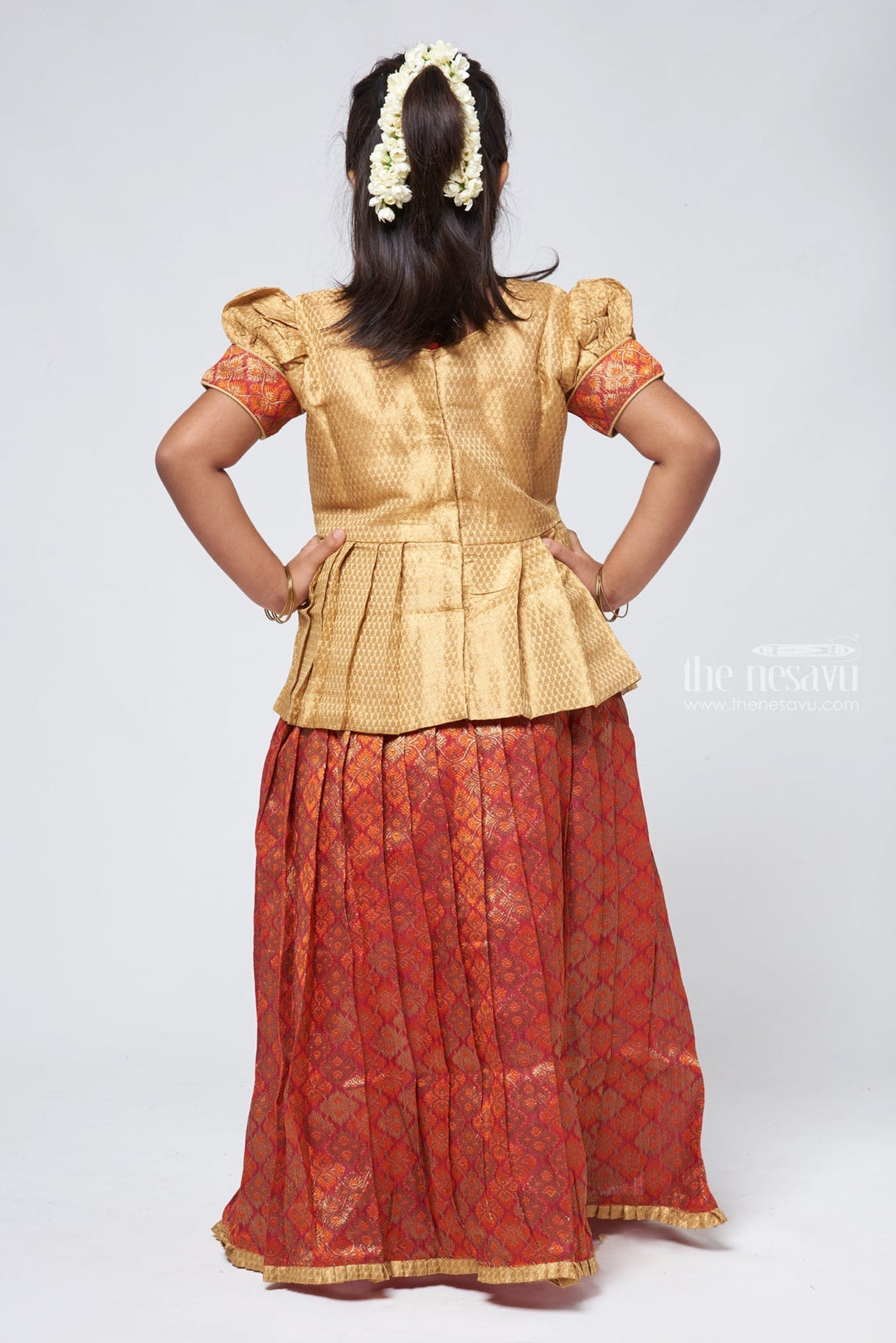 The Nesavu Pattu Pavadai Elegant Brocade Peplum Blouse paired with Zari Floral Designer Pattu Pavadai: Traditional Festive Wear Nesavu Zari Floral Pattu Pavadai | Pattu Pavadai Sattai Designs | The Nesavu