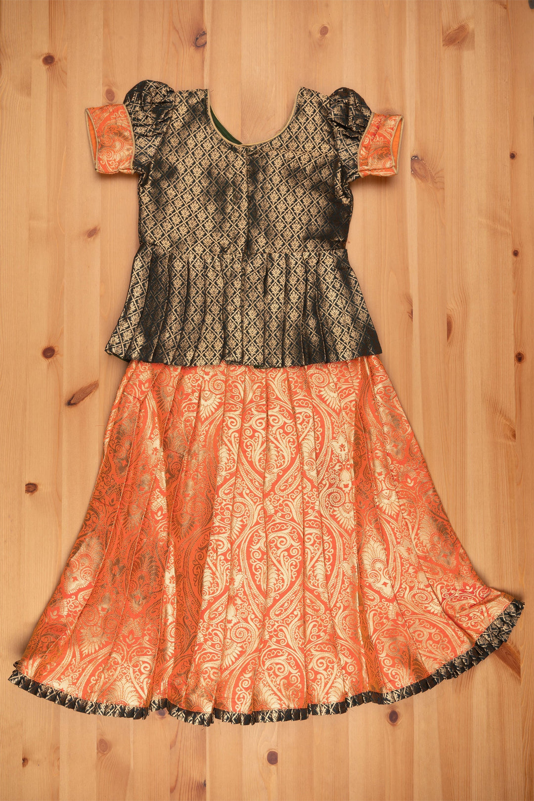 The Nesavu Pattu Pavadai Elegant Brocade Peplum Green Blouse paired with Banarasi Salmon Pink Pattu Pavadai: Timeless South Indian Nesavu Elegant Brocade Designer Pattu Pavadai for Girls | Banaras Silk Pattu Pavadai | The Nesavu