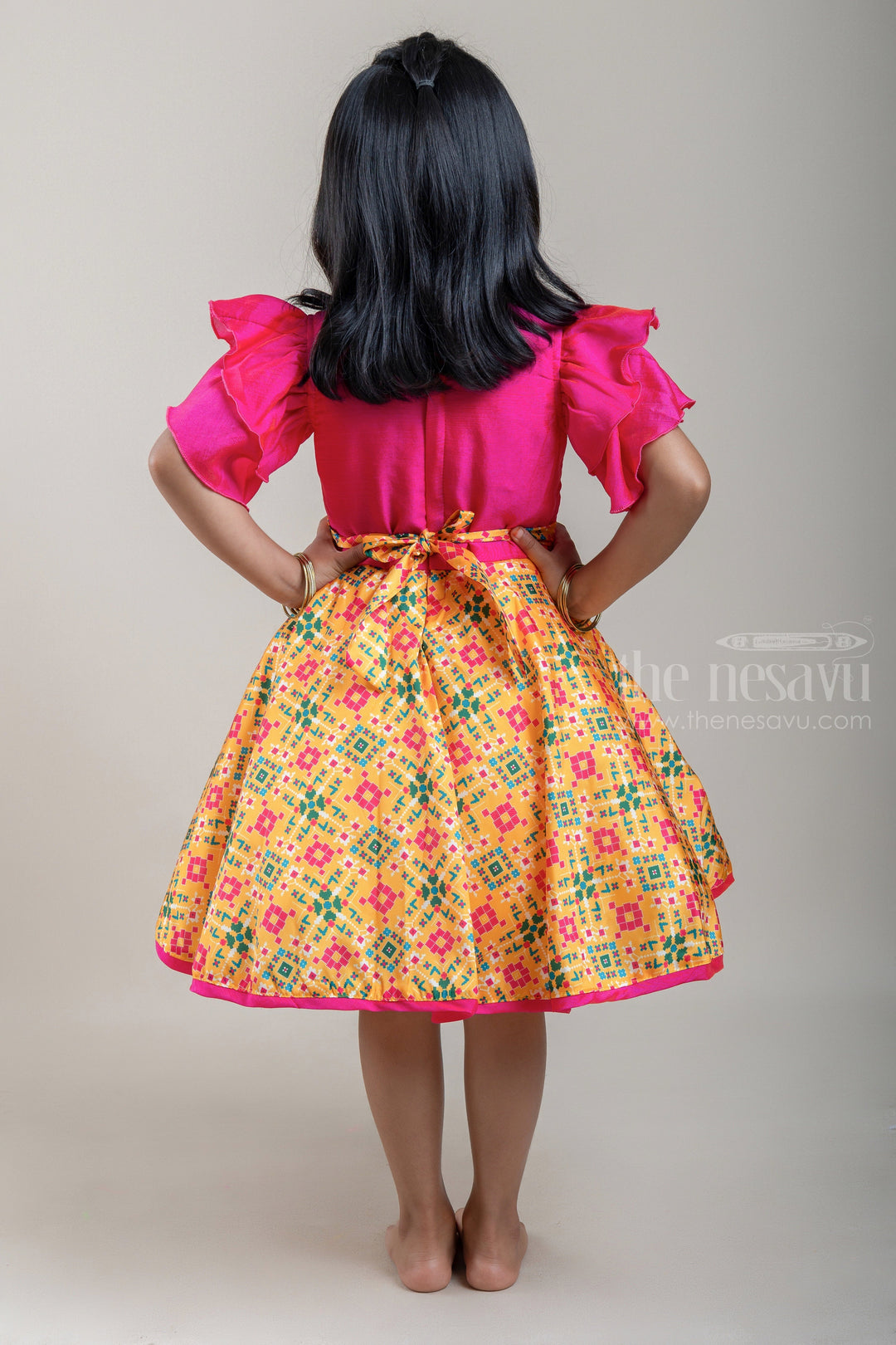 The Nesavu Silk Frocks Flared N Layered Pink Embroidered Yoke With Yellow Ikkat Printed Silk Frock For Girls psr silks Nesavu
