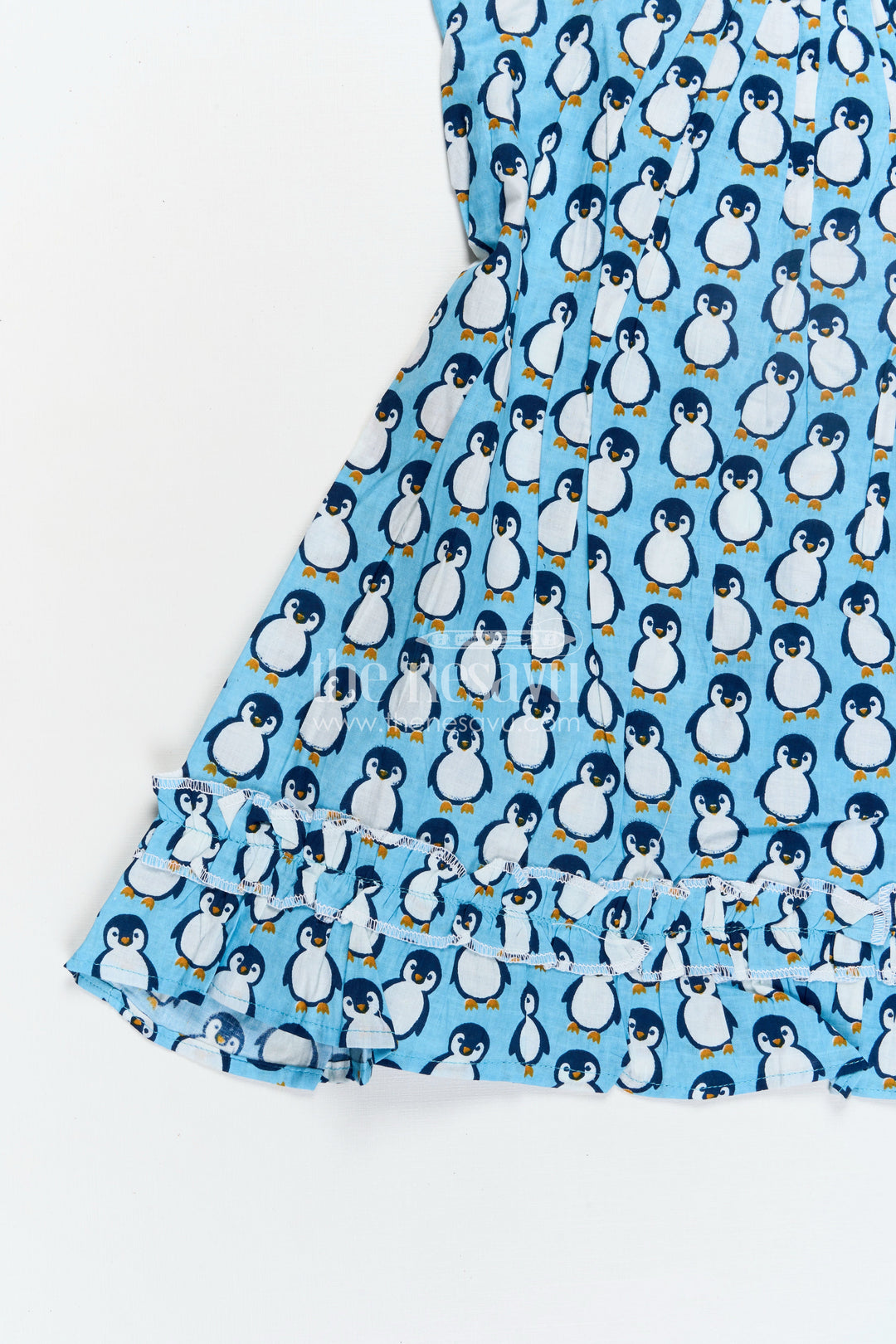 The Nesavu Girls Cotton Frock Girls Affordable Cotton Frock with Blue Penguin Hand Block Print and Frill Accents for Comfortable Wear Nesavu Nesavu Blue Hand Block Printed Affordable Cotton Frock Girls Penguin Motif Ruffle Details