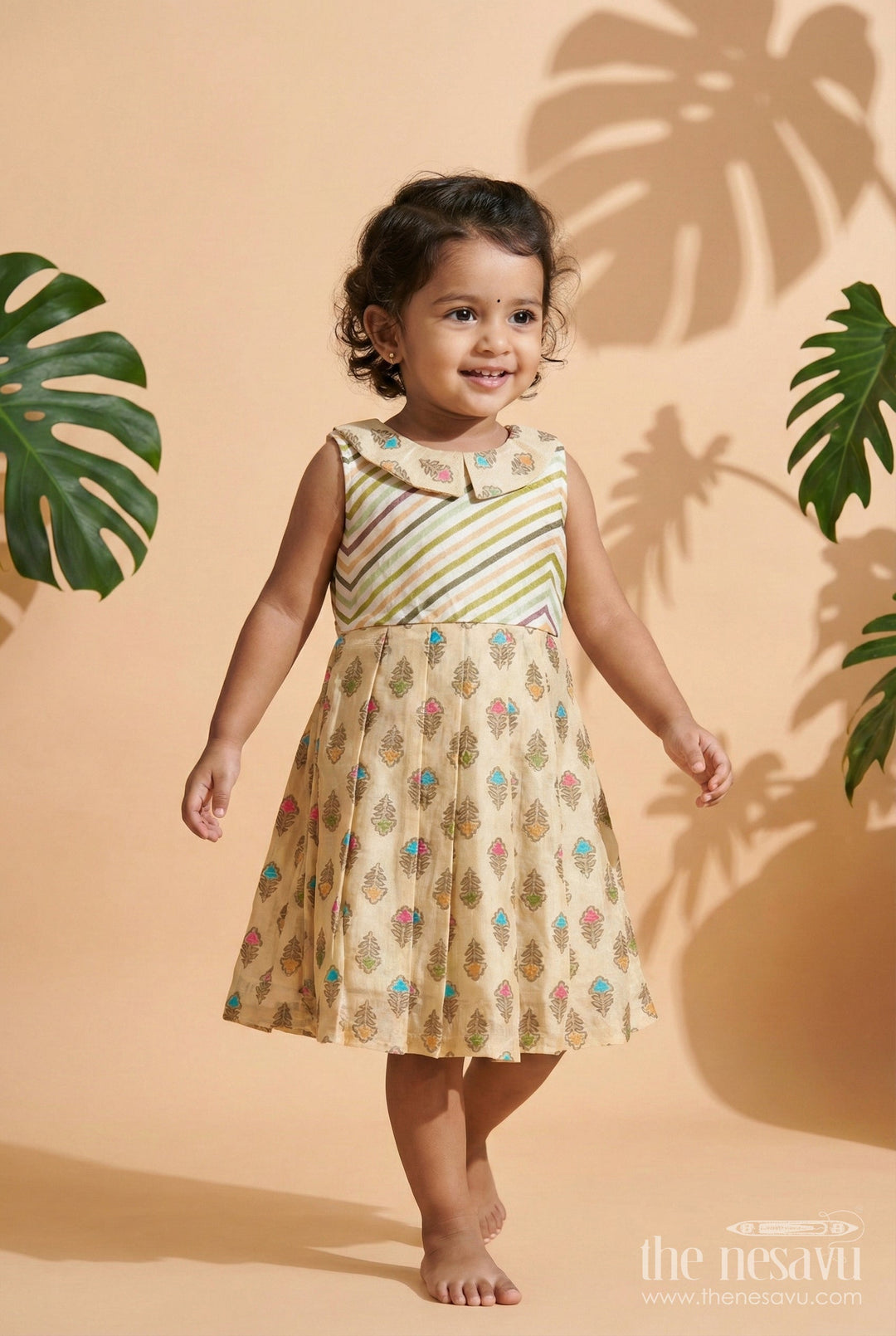 The Nesavu Girls Cotton Frock Girls Beige Cotton Frock with Earthy-Toned Floral Block Print Nesavu 18 (2Y) / Beige GFC1955B-18 Nesavu girls beige cotton frock with multicolor floral print and pleated flare