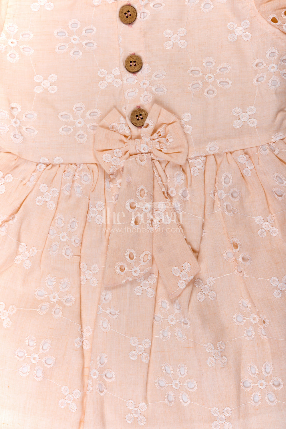 The Nesavu Girls Cotton Frock Girls Cotton Sleeveless Dress in Pastel Peach with All-Over Hakoba Floral Embroidery Nesavu Nesavu Cotton Sleeveless Dress for Girls in Peach Hakoba Fabric with Embroidery and Button Detail