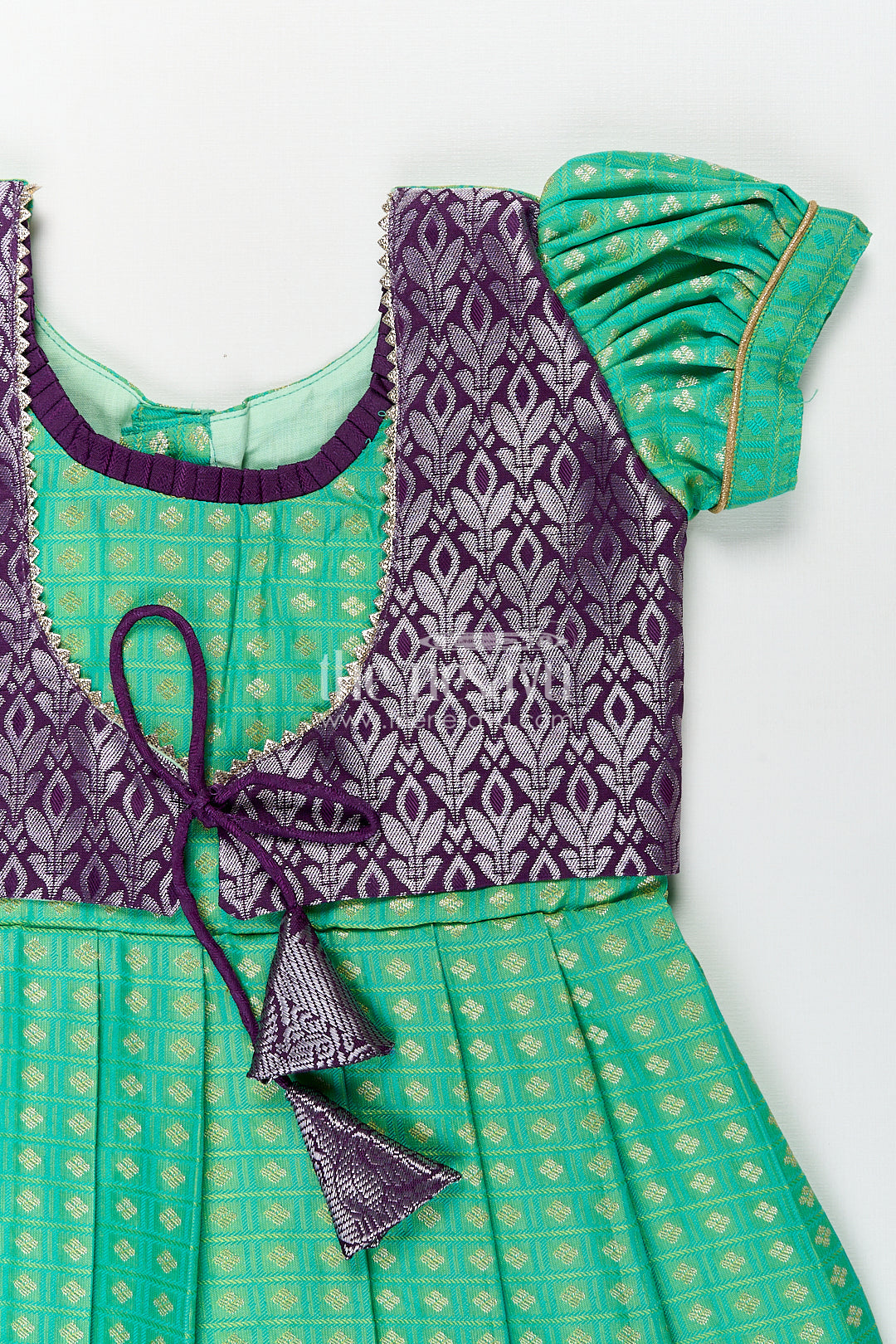 The Nesavu Girls Kanchi Silk Frock Girls Kanchivaram Silk Cotton Frocks with Puff Sleeves Green Bodice and Purple Zari Woven Skirt Nesavu Nesavu Girls Silk Cotton Frocks Kanchivaram Style Purple Zari Skirt Green Puff Sleeve Bodice