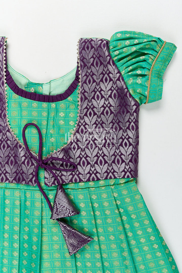 The Nesavu Girls Kanchi Silk Frock Girls Kanchivaram Silk Cotton Frocks with Puff Sleeves Green Bodice and Purple Zari Woven Skirt Nesavu Nesavu Girls Silk Cotton Frocks Kanchivaram Style Purple Zari Skirt Green Puff Sleeve Bodice