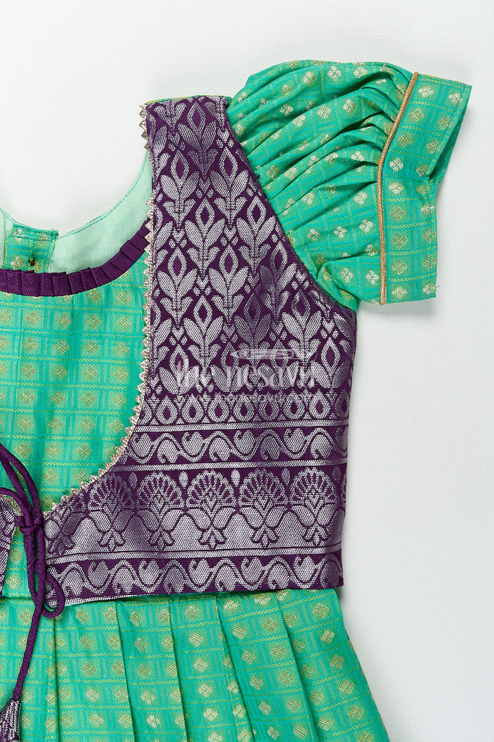 The Nesavu Girls Kanchi Silk Frock Girls Kanchivaram Silk Cotton Frocks with Puff Sleeves Green Bodice and Purple Zari Woven Skirt Nesavu Nesavu Girls Silk Cotton Frocks Kanchivaram Style Purple Zari Skirt Green Puff Sleeve Bodice