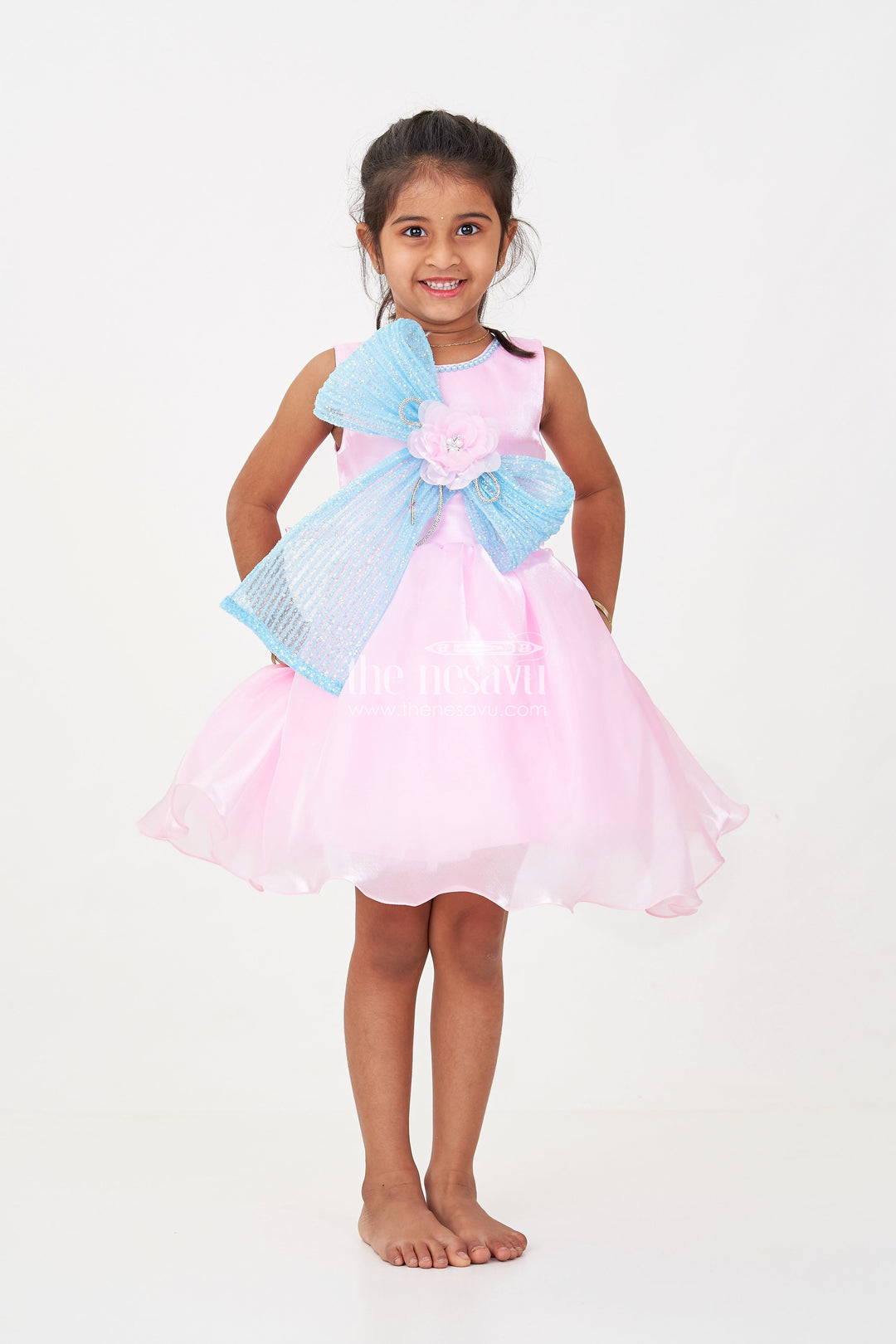 The Nesavu Girls Fancy Party Frock Girls Pink Net Frock with Blue Glitter Bow and Floral Accent in Glazed Organza Fabric Nesavu Nesavu Girls Pink Net Frock Blue Glitter Bow Glazed Organza Party Wear