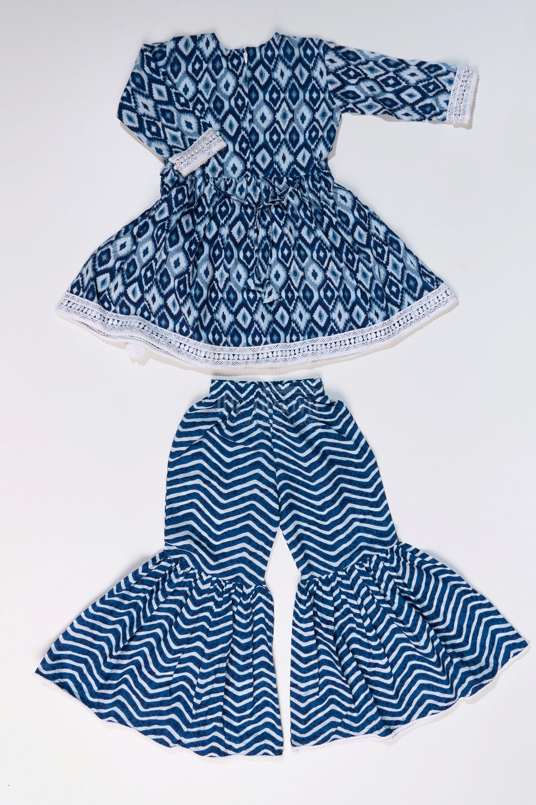 The Nesavu Girls Sharara / Plazo Set Girls Suit Plazo Set with Ikat Inspired Print and Pom-Pom Detailing in Blue and White Nesavu Nesavu Girls Blue White Suit Plazo Set Ikat Inspired Print Pom-Pom Detailing