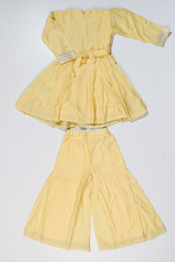 The Nesavu Girls Sharara / Plazo Set Girls Yellow Cotton Sharara Set with Silver Borders and Flared Sleeves for a Bright simple sharara suit Look Nesavu Nesavu Girls Yellow Cotton Sharara Set Silver Border Detailing simple sharara suit