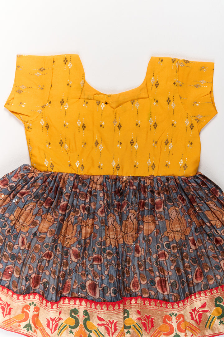 The Nesavu Silk Frock Girls Yellow Pattu Pavadai with Traditional Printed Border and Contrast Skirt for Festive Wear Nesavu Nesavu Girls Yellow Pattu Pavadai Traditional Printed Border Contrast Skirt Festive Occasions