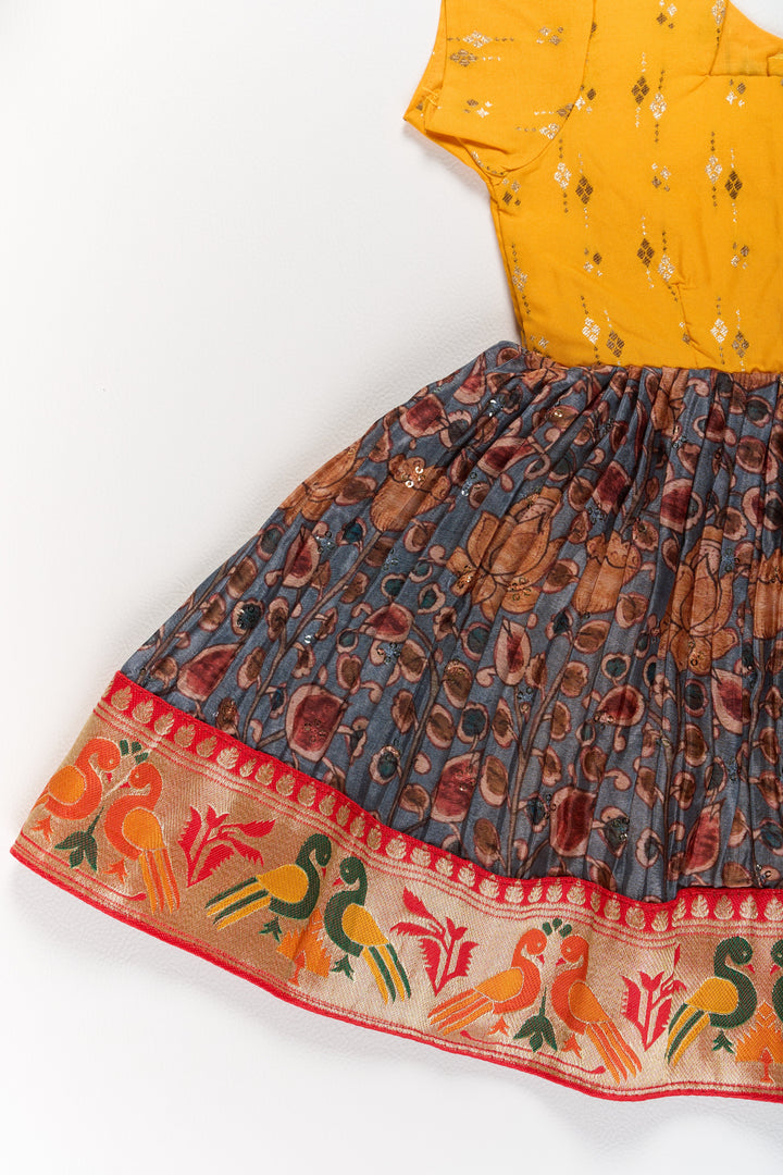 The Nesavu Silk Frock Girls Yellow Pattu Pavadai with Traditional Printed Border and Contrast Skirt for Festive Wear Nesavu Nesavu Girls Yellow Pattu Pavadai Traditional Printed Border Contrast Skirt Festive Occasions