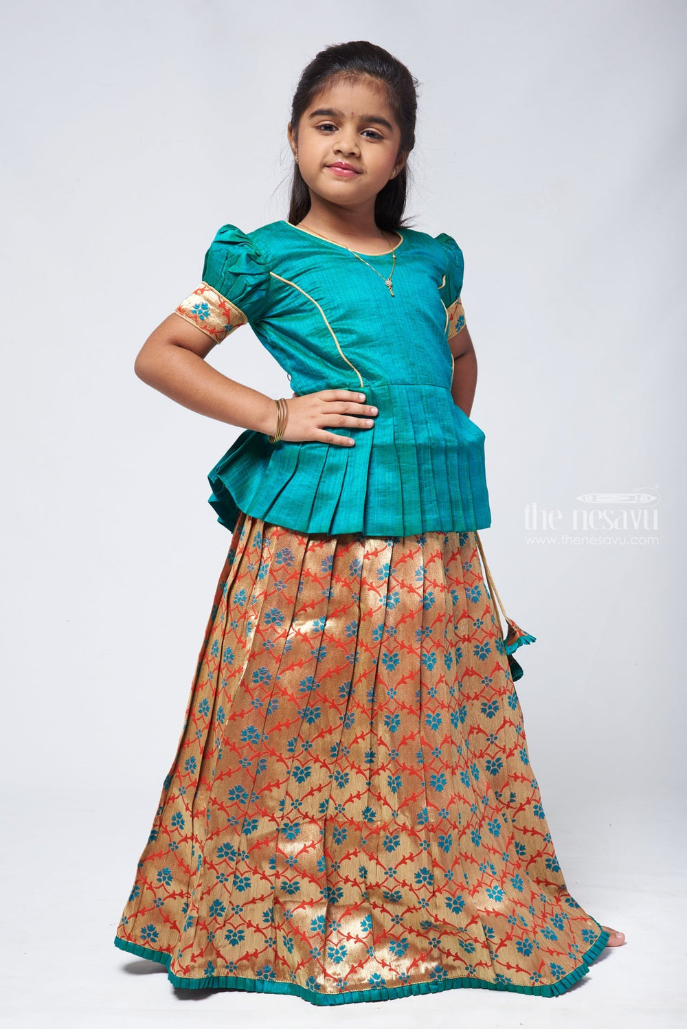 The Nesavu Pattu Pavadai Gorgeous Green Silk Peplum Blouse paired with Zari Floral Pattu Pavadai: Authentic South Indian Elegance Nesavu Pattu Pavadai with peplum blouse | Pattu Pavadai with Zari Border | The Nesavu