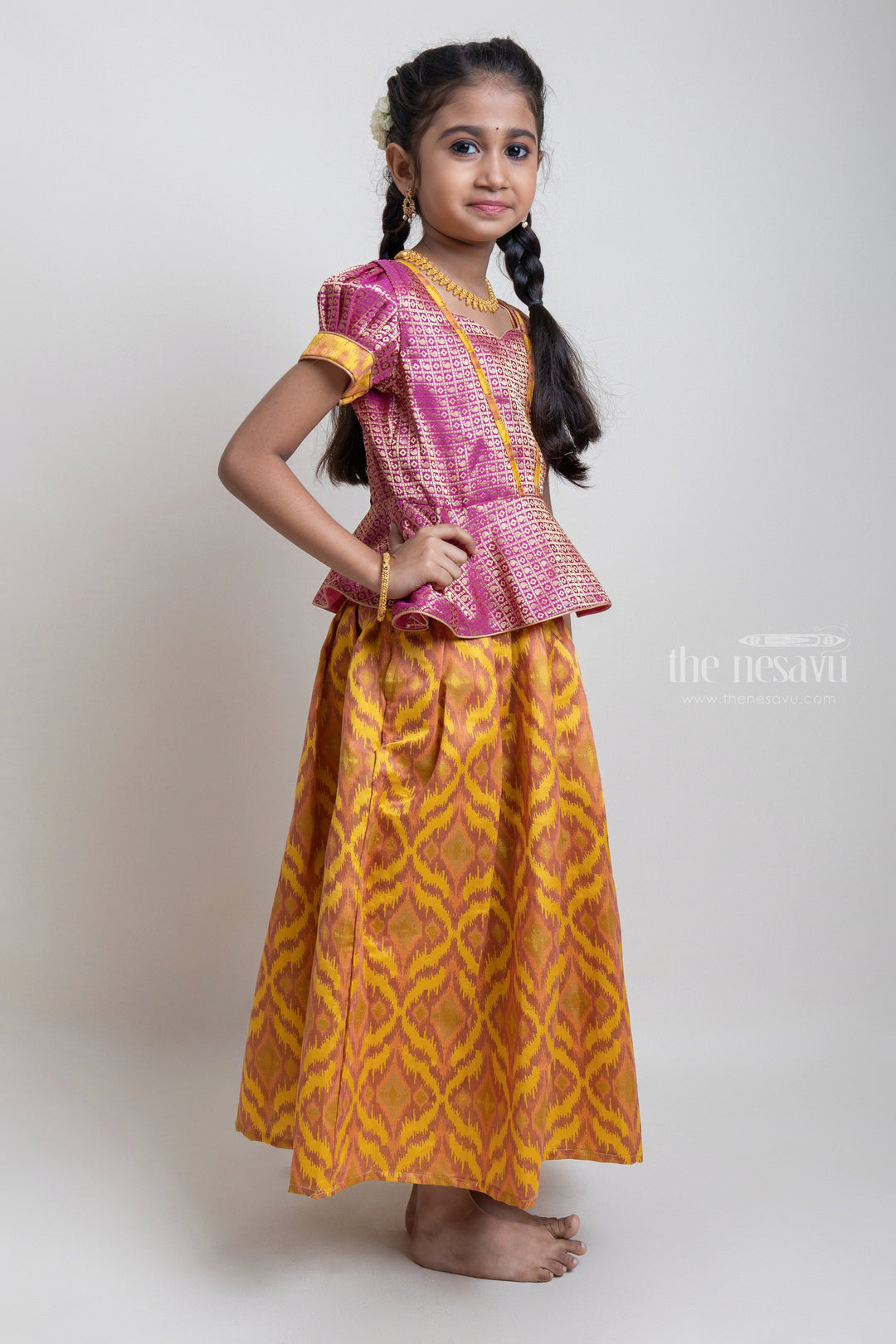 The Nesavu Pattu Pavadai Gorgeous Pink Floral Designed Silk Blouse With Woven Ikat Design Ziz-Zag Pattu Pavadai For Girls Nesavu Traditional Wear For Girls | Latest Pattu Pavadai | The Nesavu