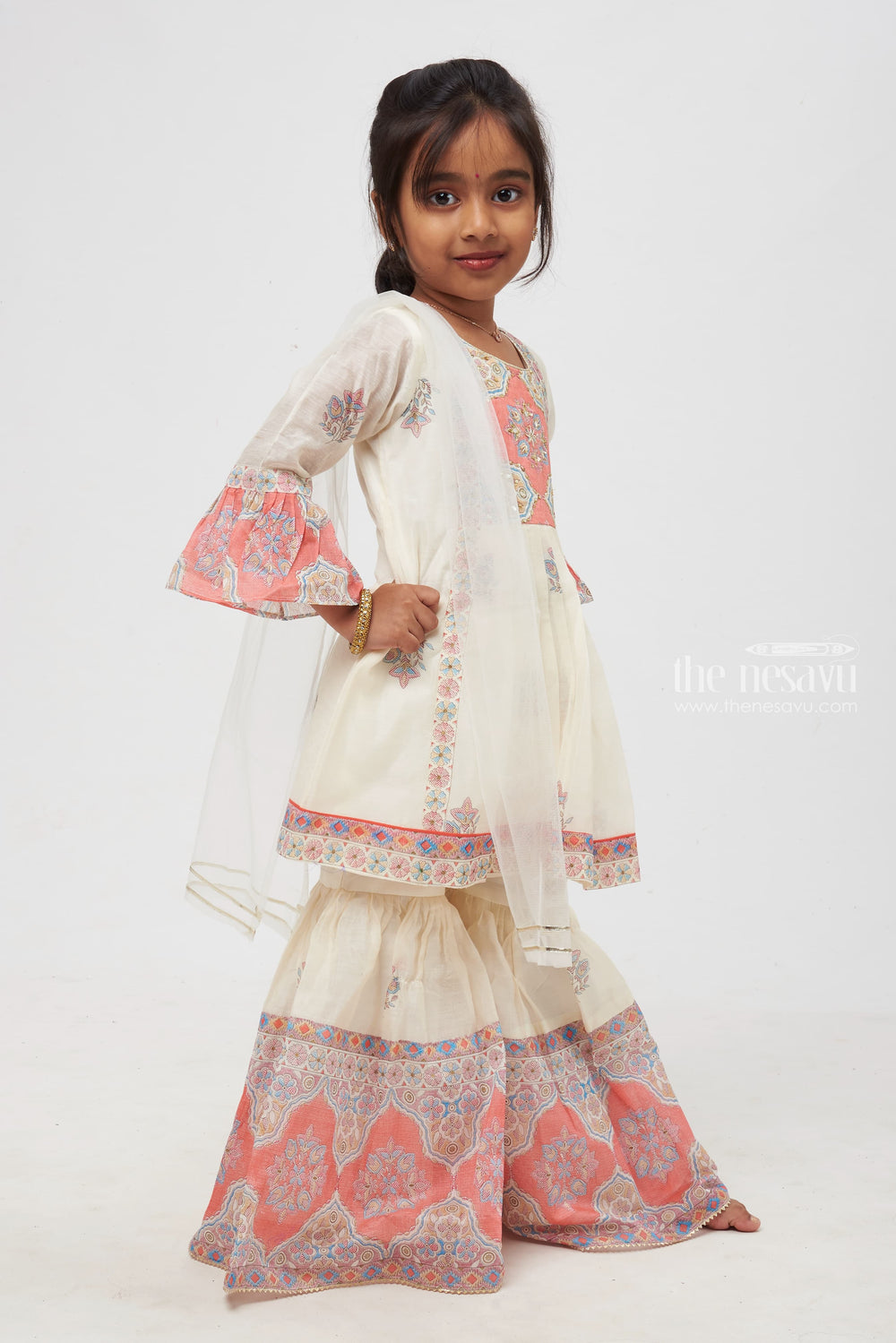 The Nesavu Girls Sharara / Plazo Set Graceful Tile-Inspired Ensemble for Kids: White and Pink Floral Printed Stylish Kurti with Sharara Pant Set Nesavu Kids Graceful Tile-Inspired Ensemble | Off-White with Coral and Muted Blue Details | Elegant Festive Wear