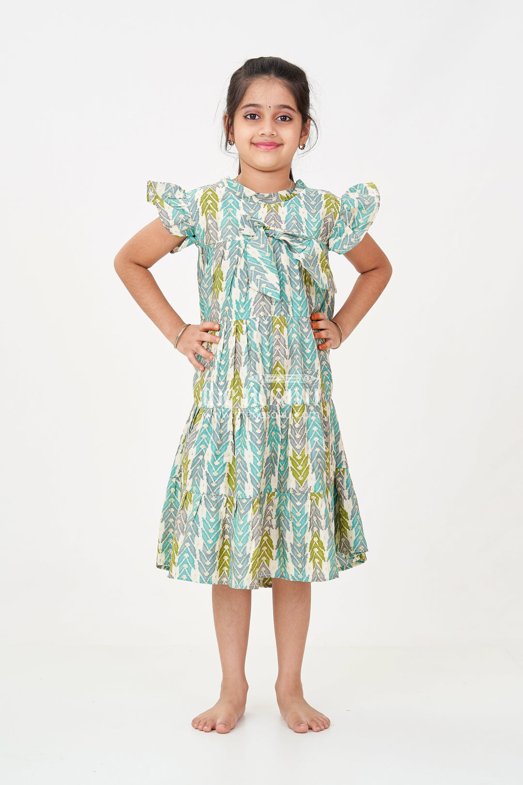 The Nesavu Girls Cotton Frock Green Colour Frock for Girls in Modal Silk with Multicolor Geometric Print and Front Bow Design Nesavu 18 (2Y) / Green GFC1696B-18 Nesavu Green Colour Frock Girls Modal Silk Multicolor Geometric Print Front Bow