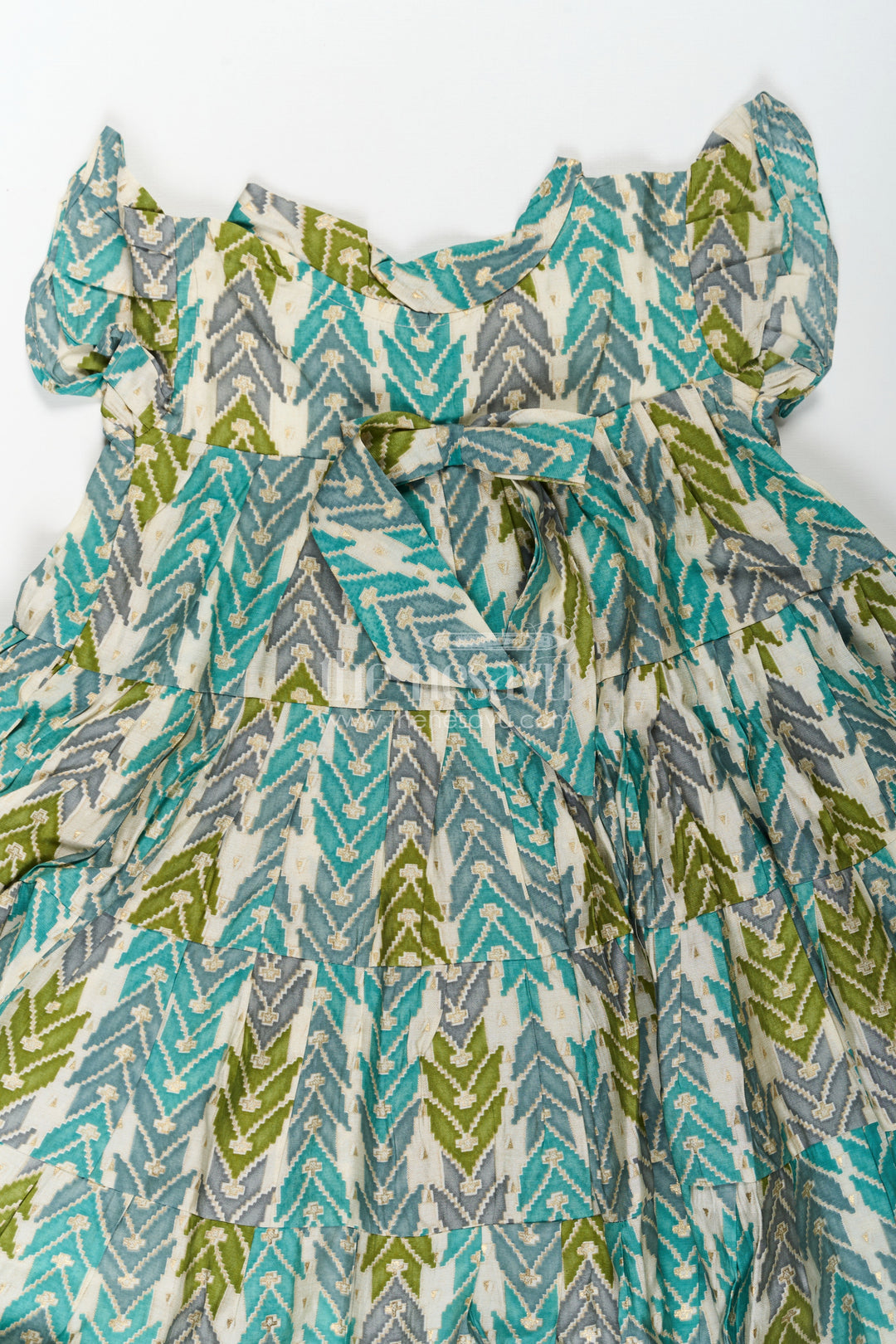 The Nesavu Girls Cotton Frock Green Colour Frock for Girls in Modal Silk with Multicolor Geometric Print and Front Bow Design Nesavu Nesavu Green Colour Frock Girls Modal Silk Multicolor Geometric Print Front Bow