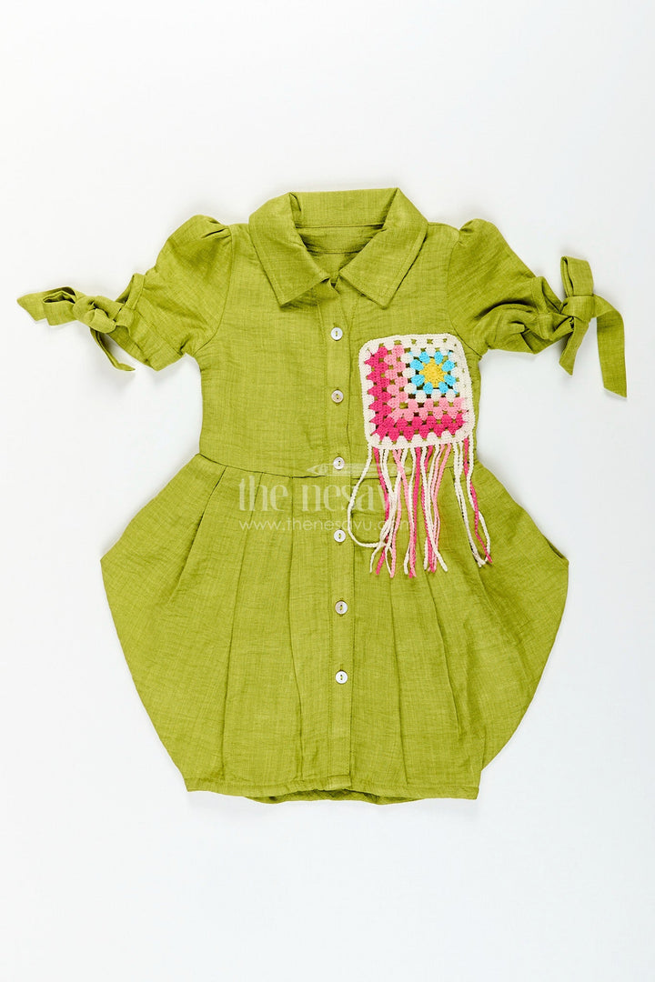 The Nesavu Girls Cotton Frock Green girls cotton frock with crochet patch and tie-up sleeves Nesavu Nesavu green girls cotton frock with crochet pocket patch and tassel detail