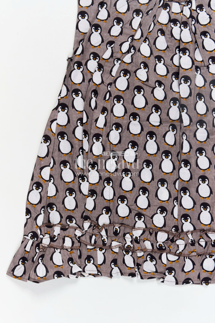 The Nesavu Girls Cotton Frock Kids Casual Cotton Printed Frock for Girls with Brown Penguin Block Print and Frilled Shoulders Nesavu Nesavu Brown Hand Block Kids Casual Cotton Printed Frock Penguin Motifs Ruffled Design