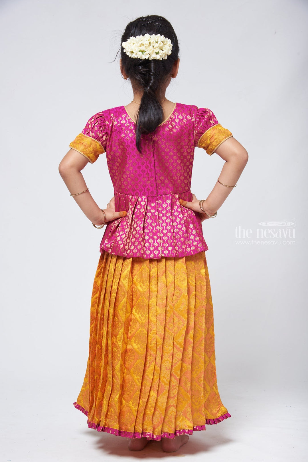The Nesavu Pattu Pavadai Lavish Brocade Purple Peplum Top with Banarasi Yellow Silk Pavadai: South Indian Elegance Nesavu Pattu Pavadai with peplum blouse | Pattu Pavadai Latest Design | The Nesavu