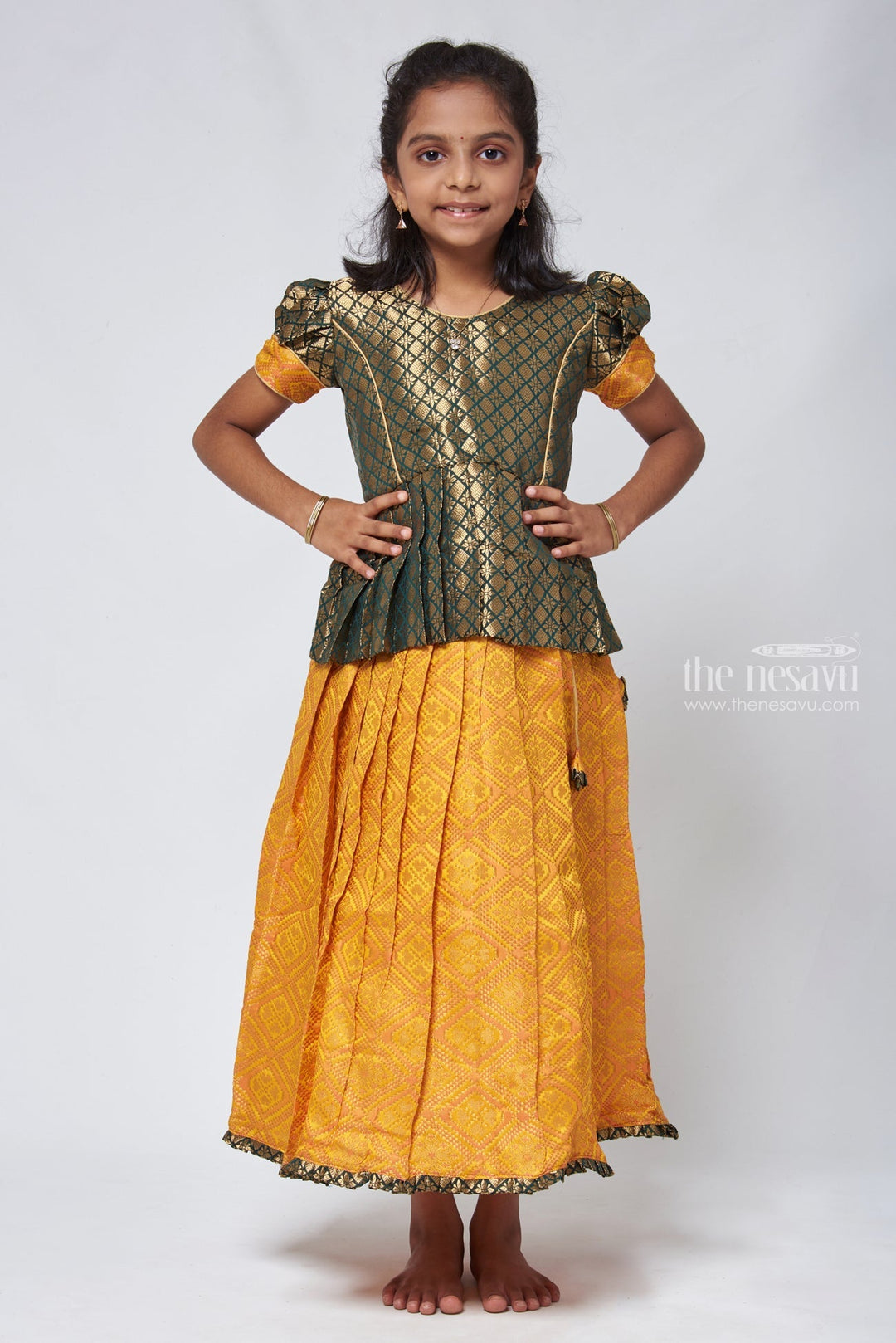 The Nesavu Pattu Pavadai Majestic Brocade Green Peplum Blouse paired with Patola Yellow Pattu Pavadai: Timeless South Indian Fashion Nesavu 14 (6M) / Yellow GPP306A-14 Pattu Pavadai with neck designs | Girls traditional silk dresses | The Nesavu