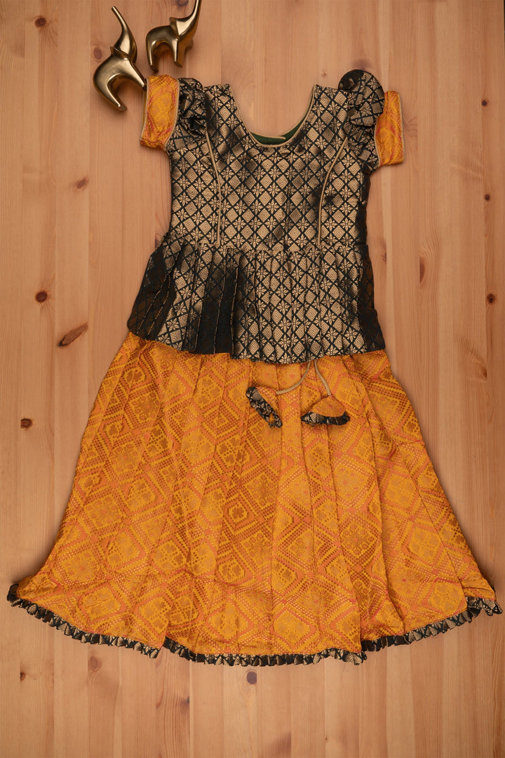 The Nesavu Pattu Pavadai Majestic Brocade Green Peplum Blouse paired with Patola Yellow Pattu Pavadai: Timeless South Indian Fashion Nesavu Pattu Pavadai with neck designs | Girls traditional silk dresses | The Nesavu