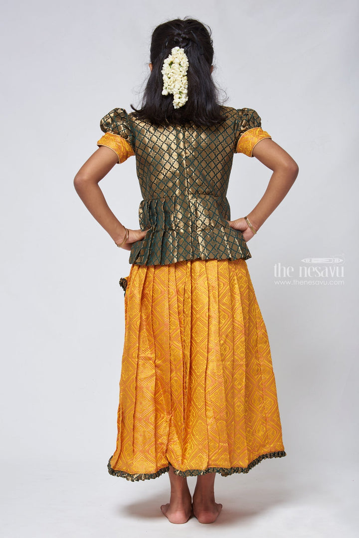 The Nesavu Pattu Pavadai Majestic Brocade Green Peplum Blouse paired with Patola Yellow Pattu Pavadai: Timeless South Indian Fashion Nesavu Pattu Pavadai with neck designs | Girls traditional silk dresses | The Nesavu