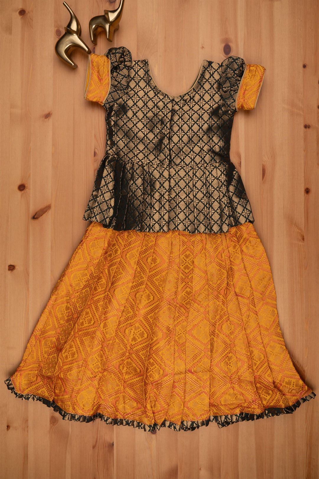 The Nesavu Pattu Pavadai Majestic Brocade Green Peplum Blouse paired with Patola Yellow Pattu Pavadai: Timeless South Indian Fashion Nesavu Pattu Pavadai with neck designs | Girls traditional silk dresses | The Nesavu